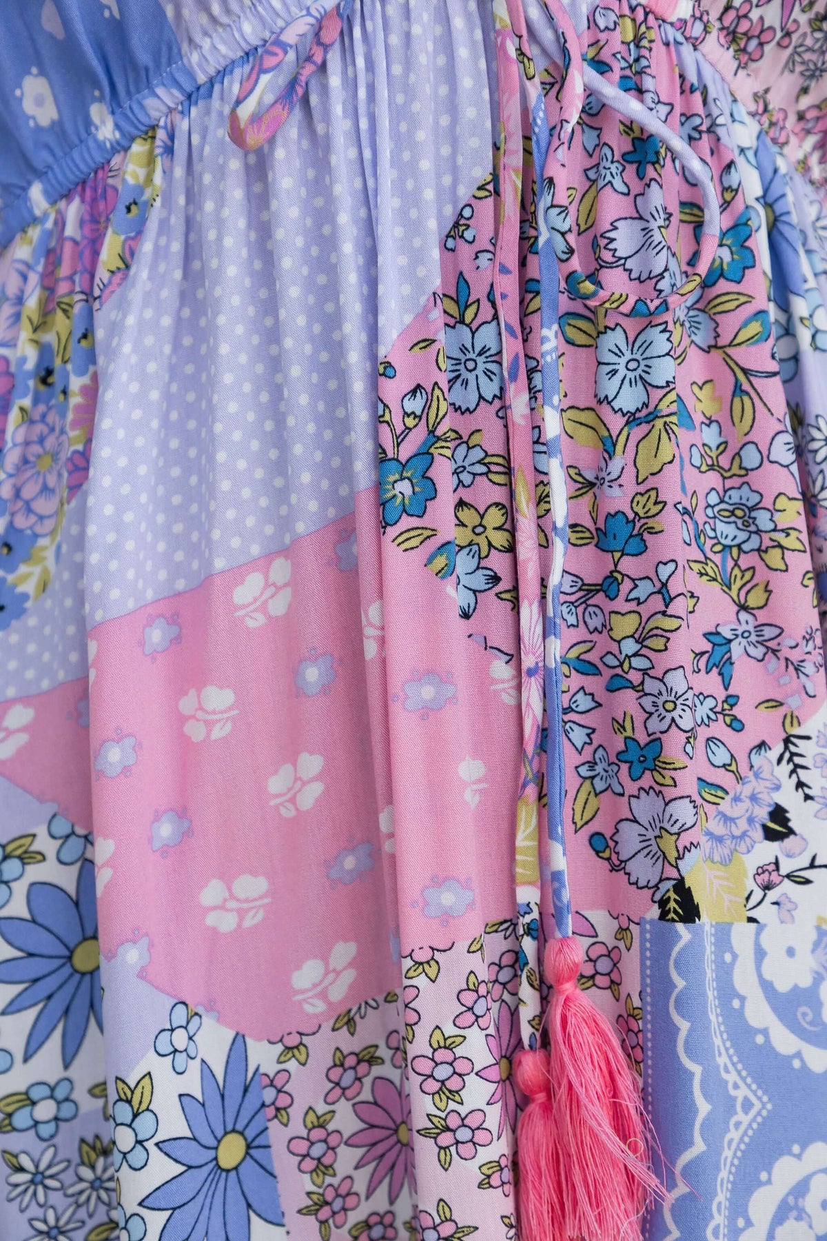 Endless Evening Maxi Dress featuring a colorful floral print and playful tassel detailing.