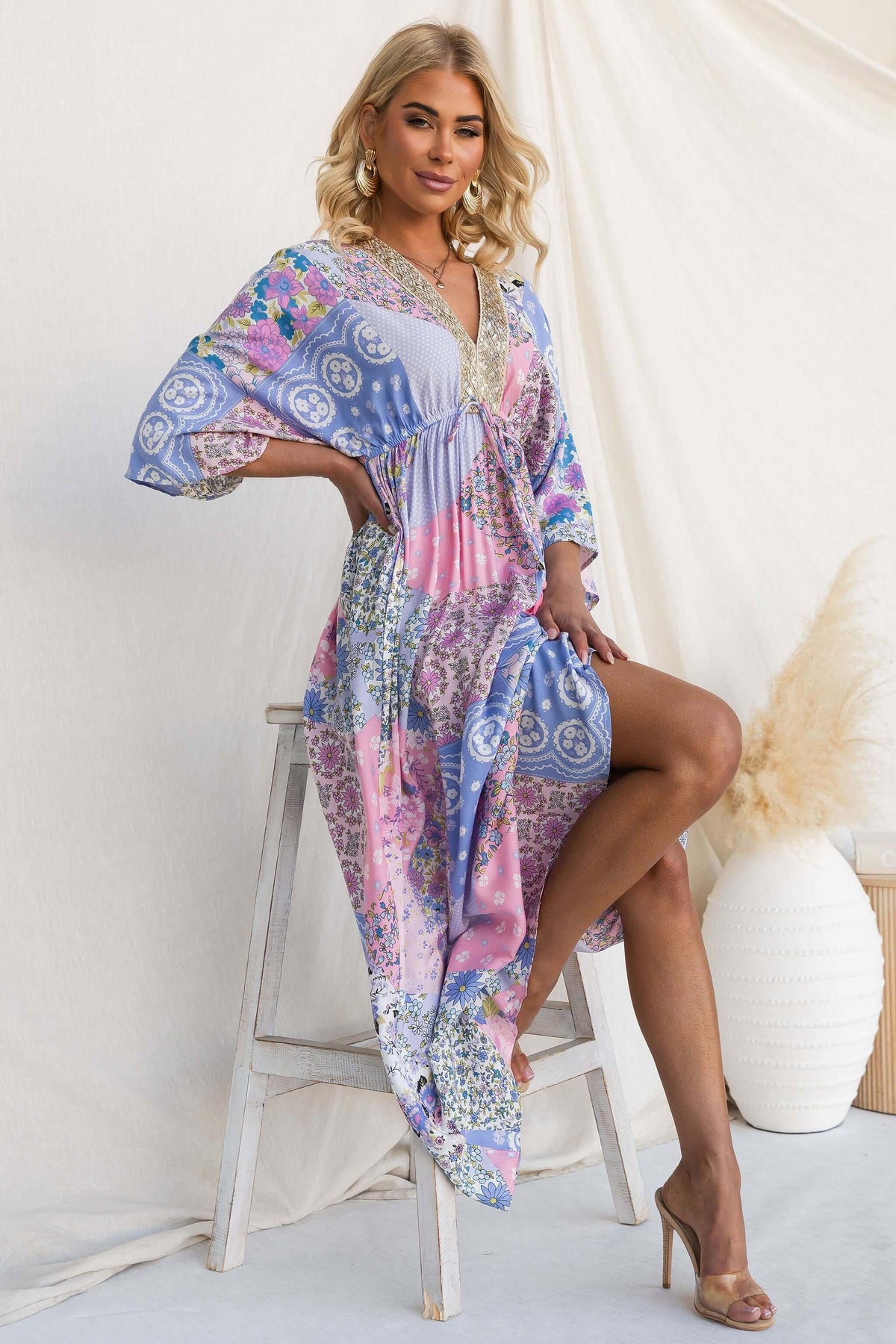 Endless Evening Maxi Dress featuring a V-neckline and vibrant floral patterns, styled with elegant accessories.