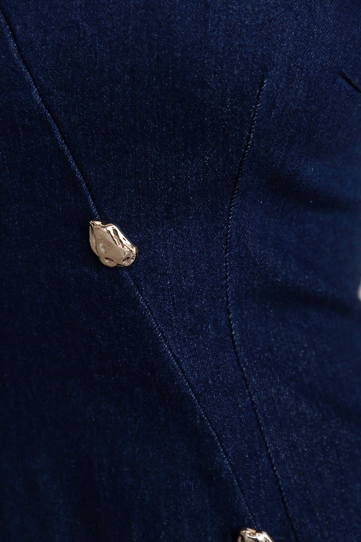 Close-up of the faux button detailing on the Darling Denim Dress fabric. Stylish high neck denim dress with stretch.