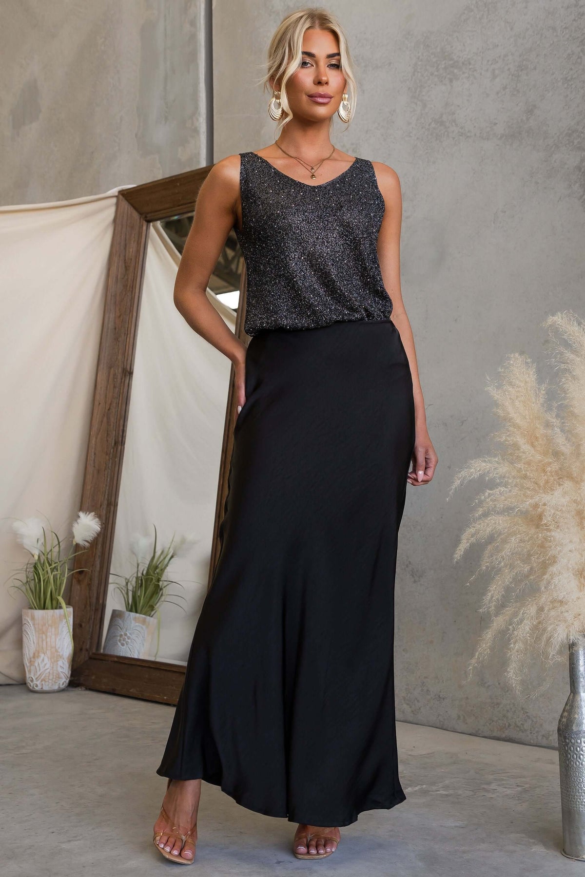 Model wearing the Moonlit Muse Maxi Skirt paired with a sparkly top in a stylish setting.