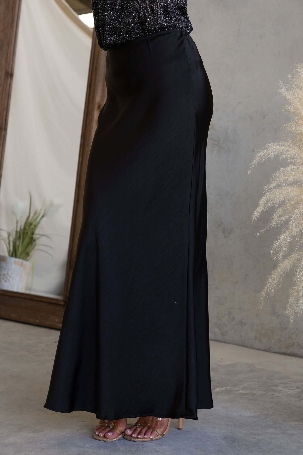 Moonlit Muse Maxi Skirt displayed in black satin with a mid-high waist fit and elegant drape.