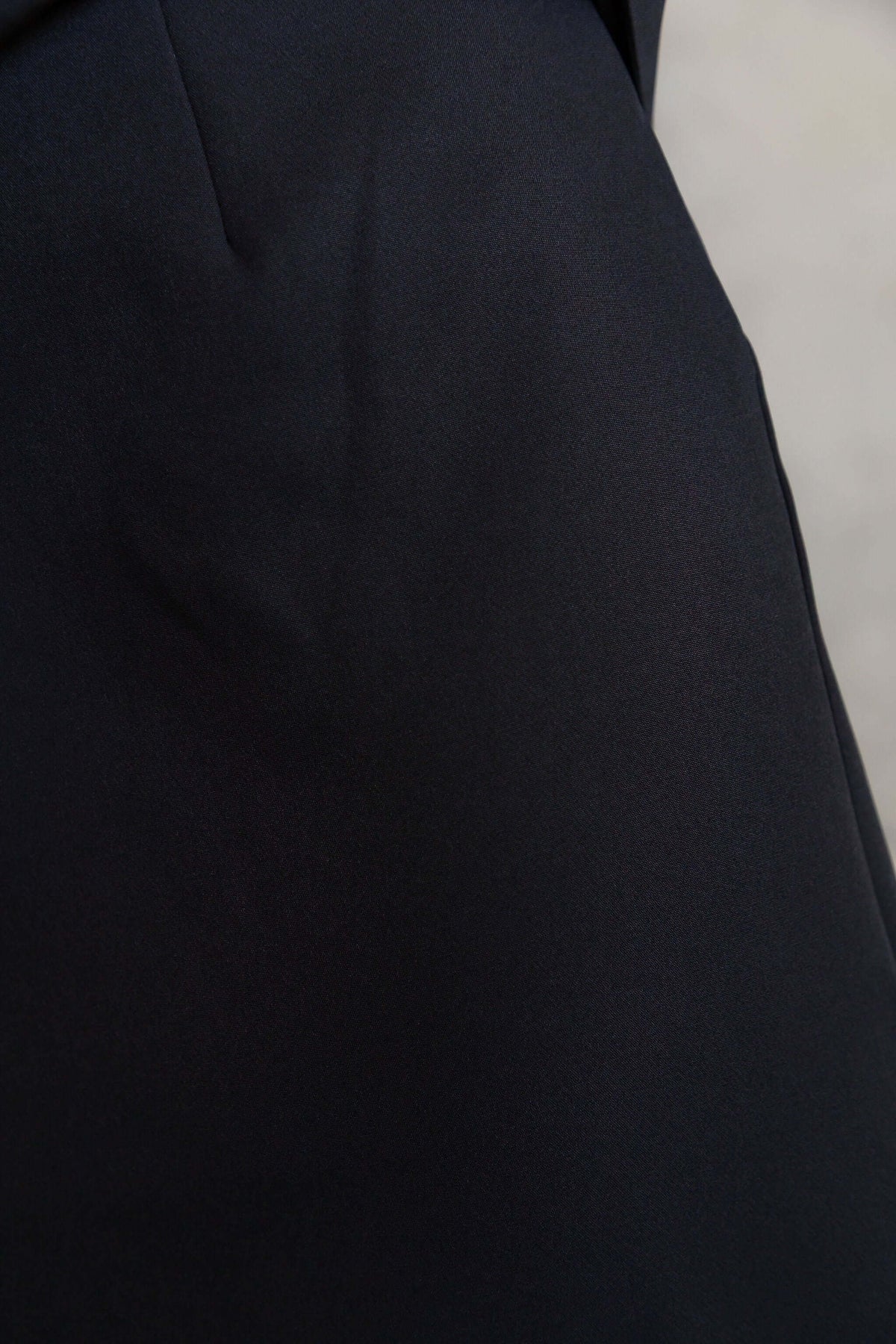 Close-up of the Duchess Maxi Skirt in black with elegant fabric texture.