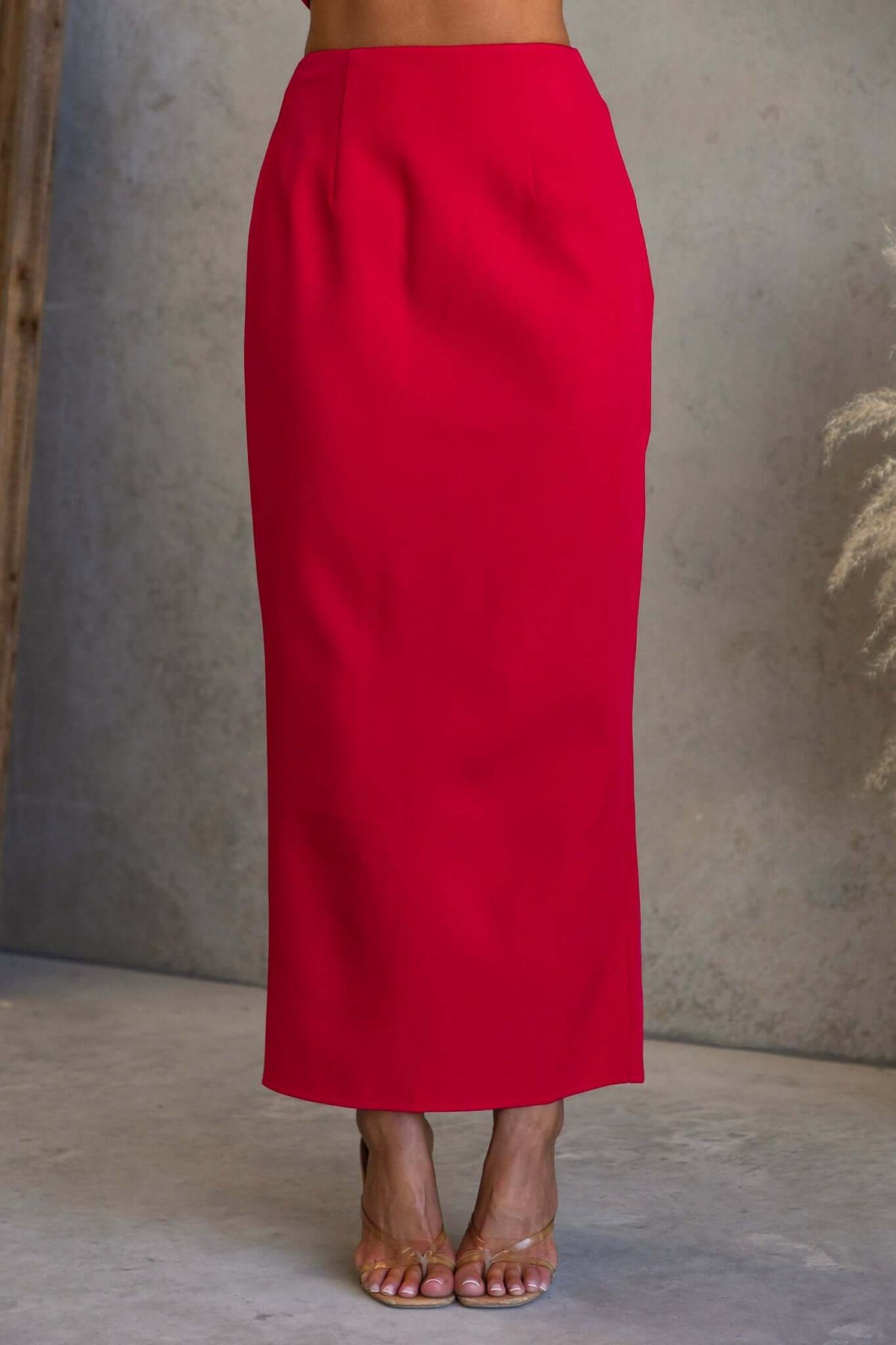 Duchess Maxi Skirt in vibrant red color, mid-high waist fit with an invisible zip and split at the back.
