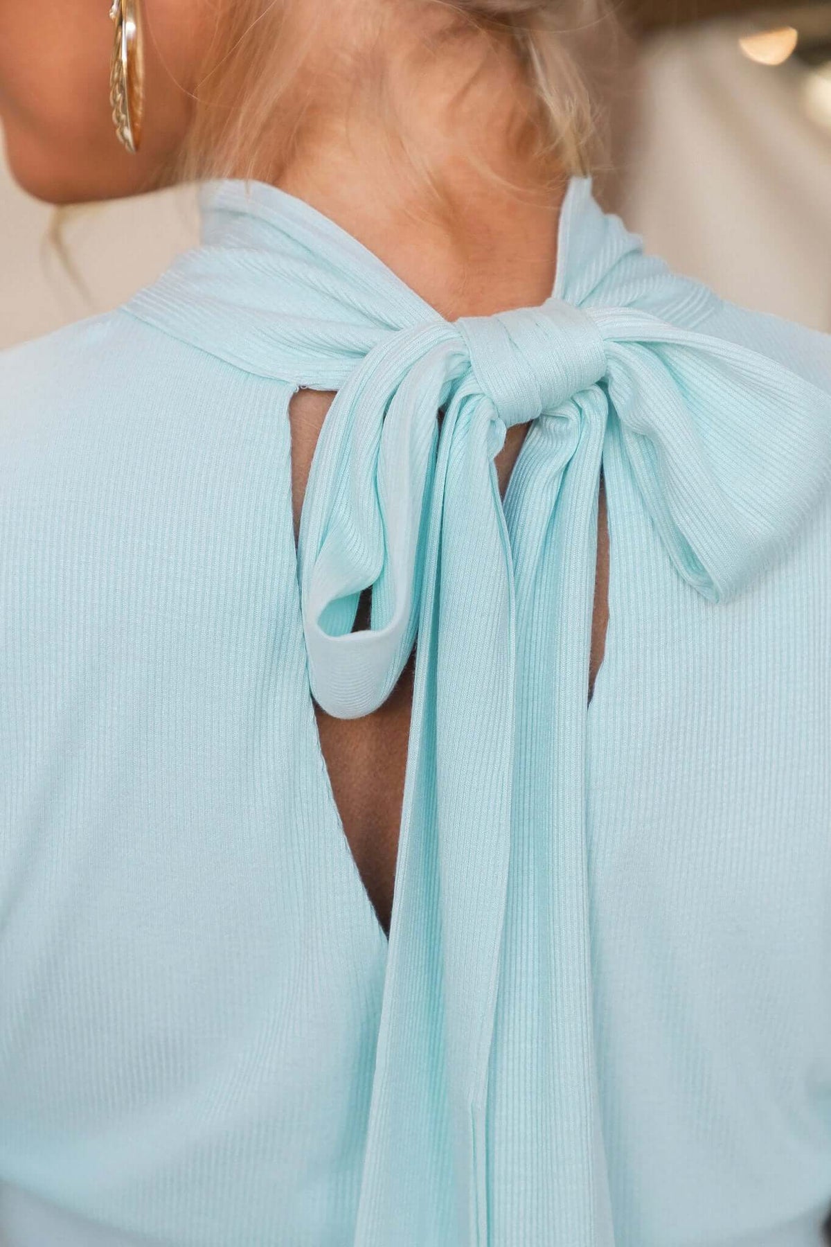 Close-up of the back tie detail of the Manor Top, featuring a high neckline and ribbed material.