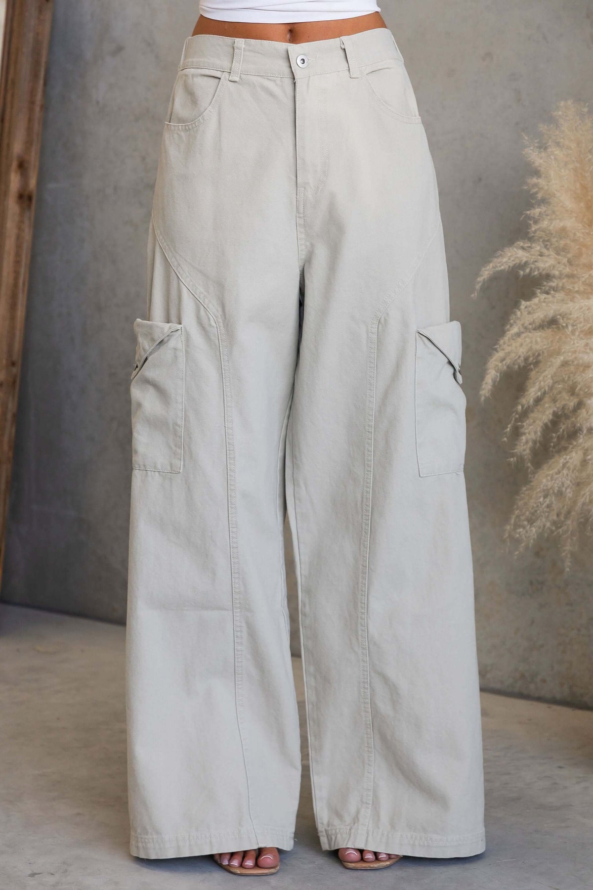 Rebel Cargo Jeans featuring a mid-high waist fit, elastic back, and cargo pockets in a light color.