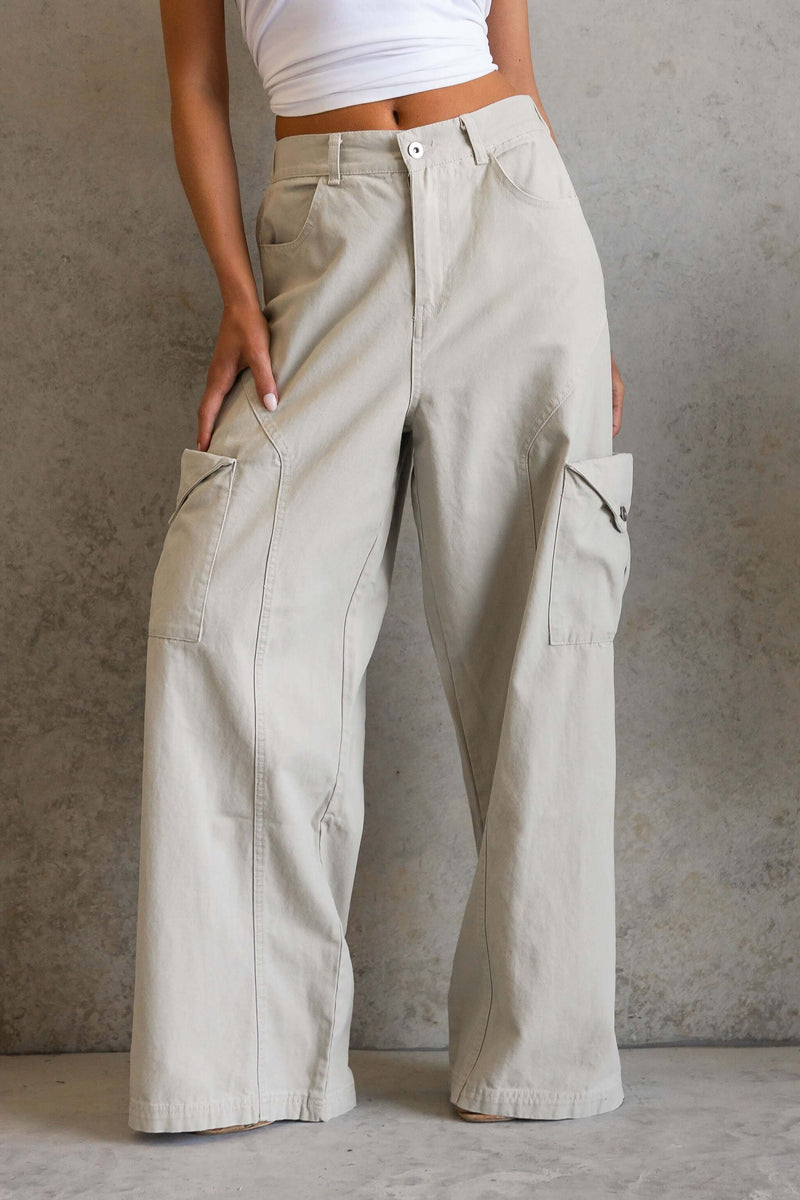 Model wearing Rebel Cargo Jeans with pockets and zip closure, showcasing a mid-high waist fit.