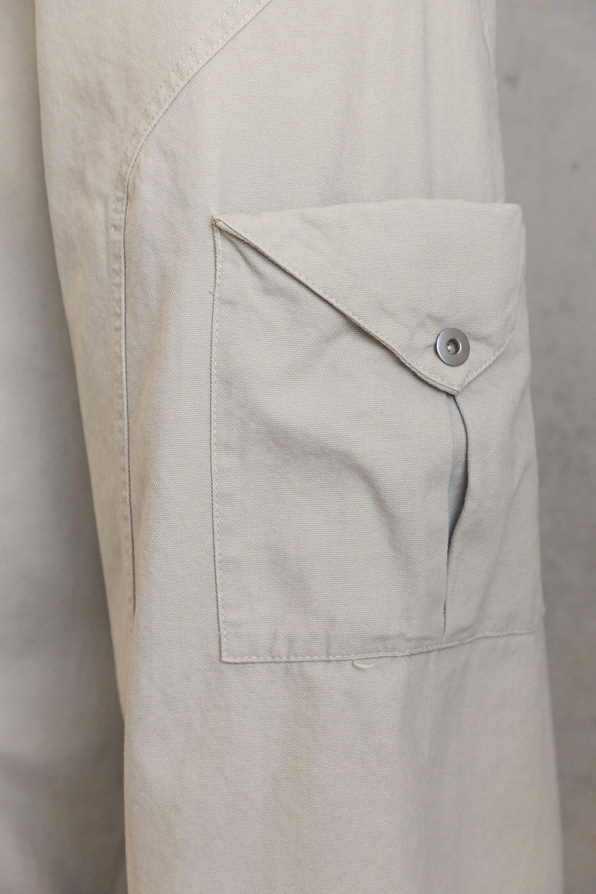 Close-up of pocket detail on Rebel Cargo Jeans showcasing the fabric and button.