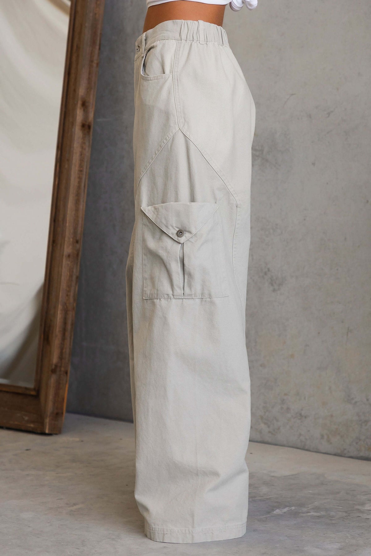 Side view of Rebel Cargo Jeans featuring a mid-high waist fit and pockets, displayed against a minimal background.