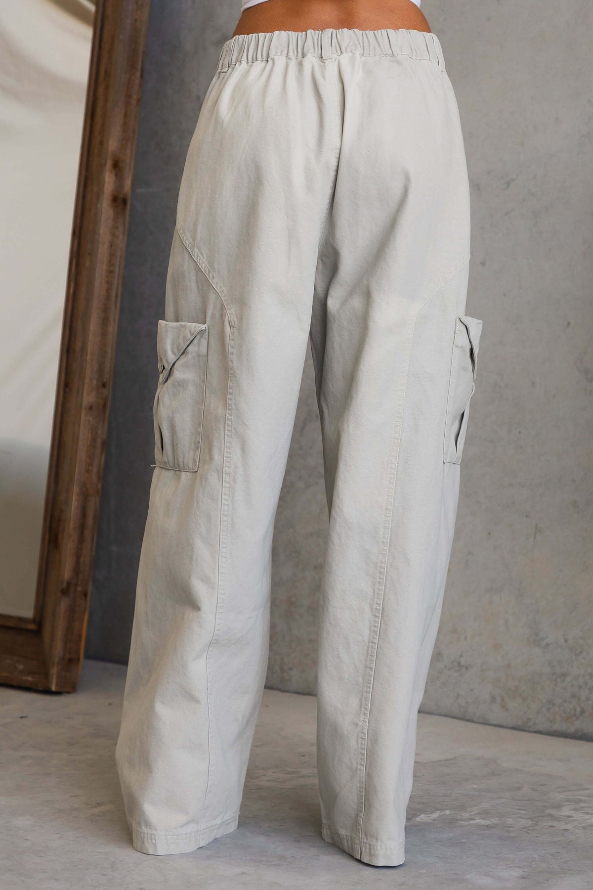 Rebel Cargo Jeans with mid-high waist fit, elastic back waistband, and pockets, showcased from the back.