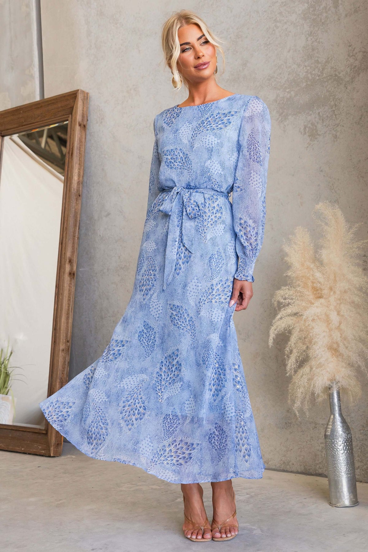 Model wearing the Morning Light Maxi Dress with floral patterns and a tie, showcasing its elegant fit.