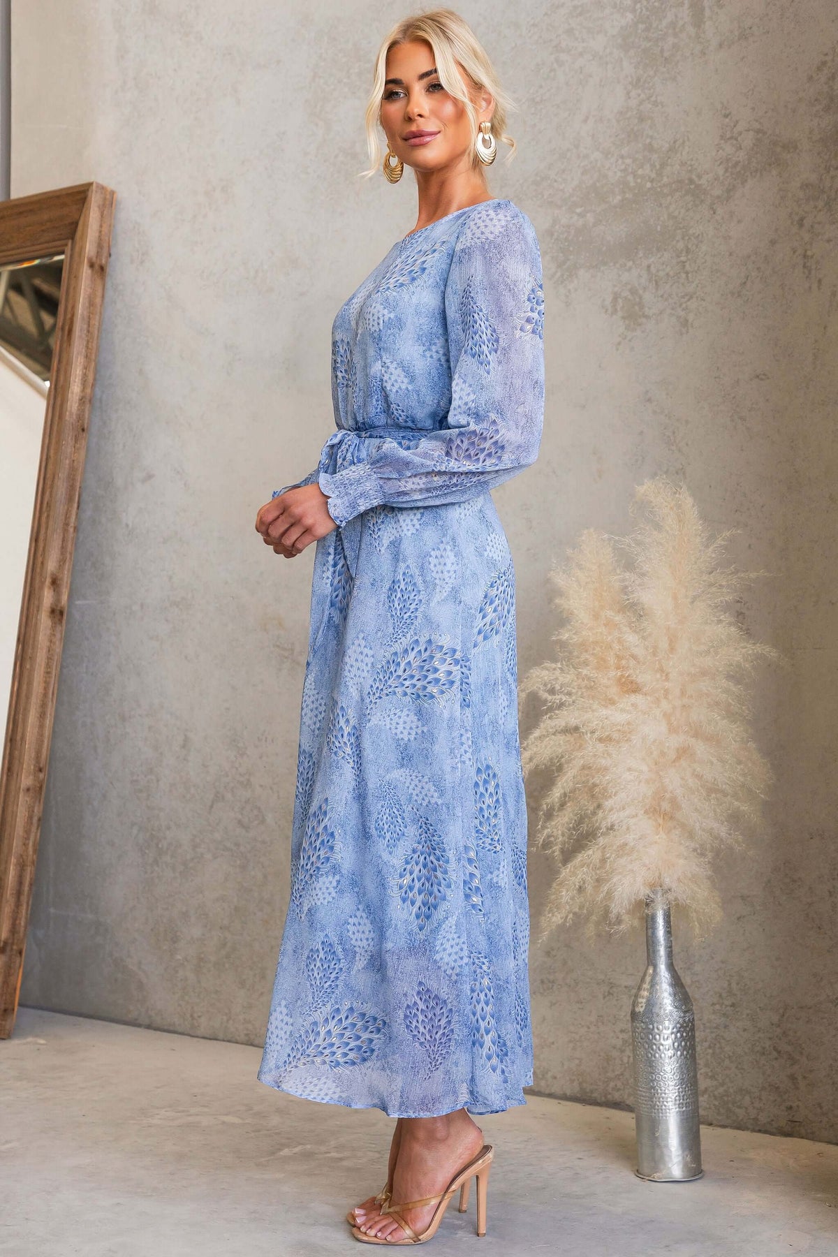 Model wearing Morning Light Maxi Dress with floral pattern, styled with accessories and set against a neutral backdrop.