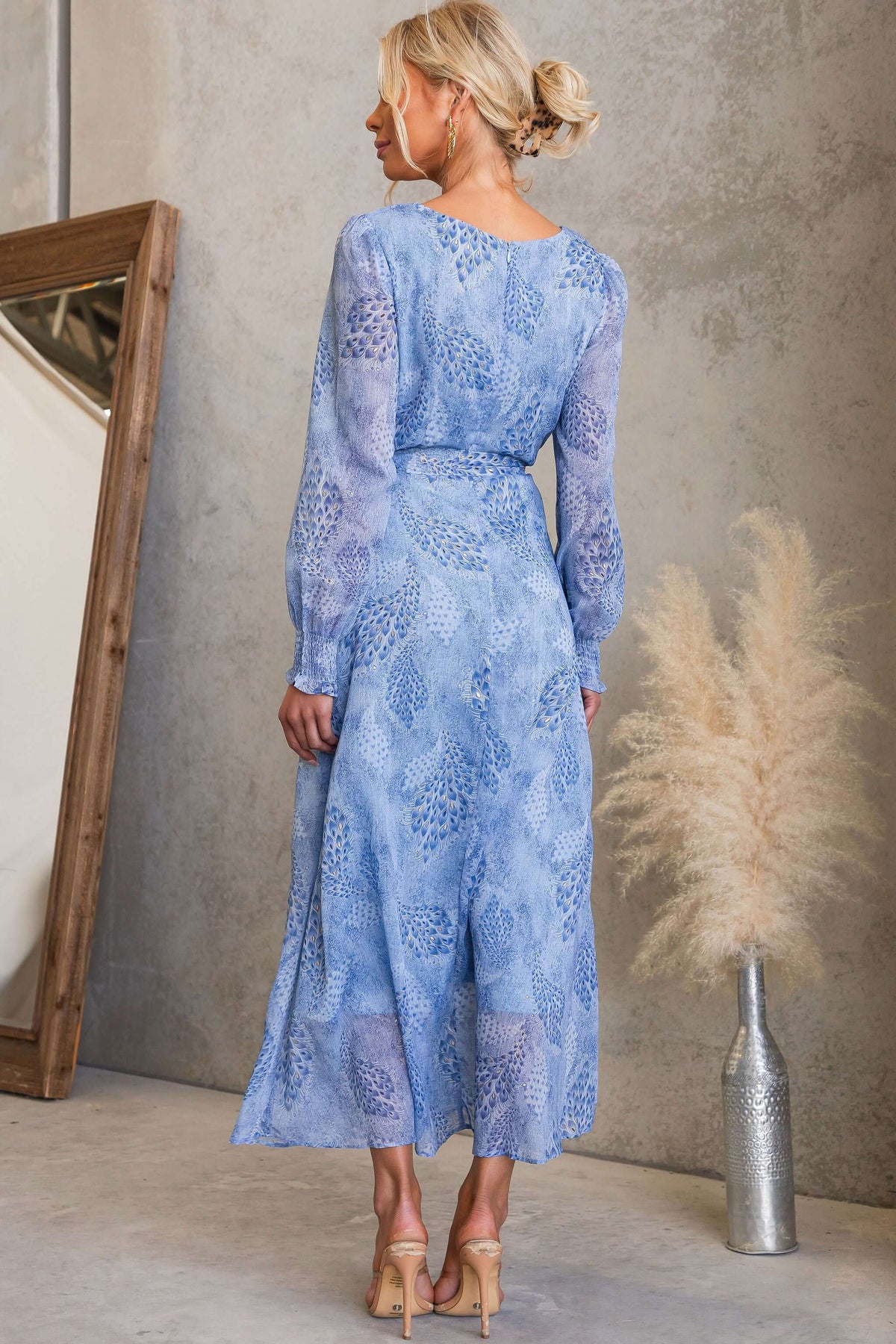 Back view of the Morning Light Maxi Dress featuring a blue floral pattern and elegant long sleeves.