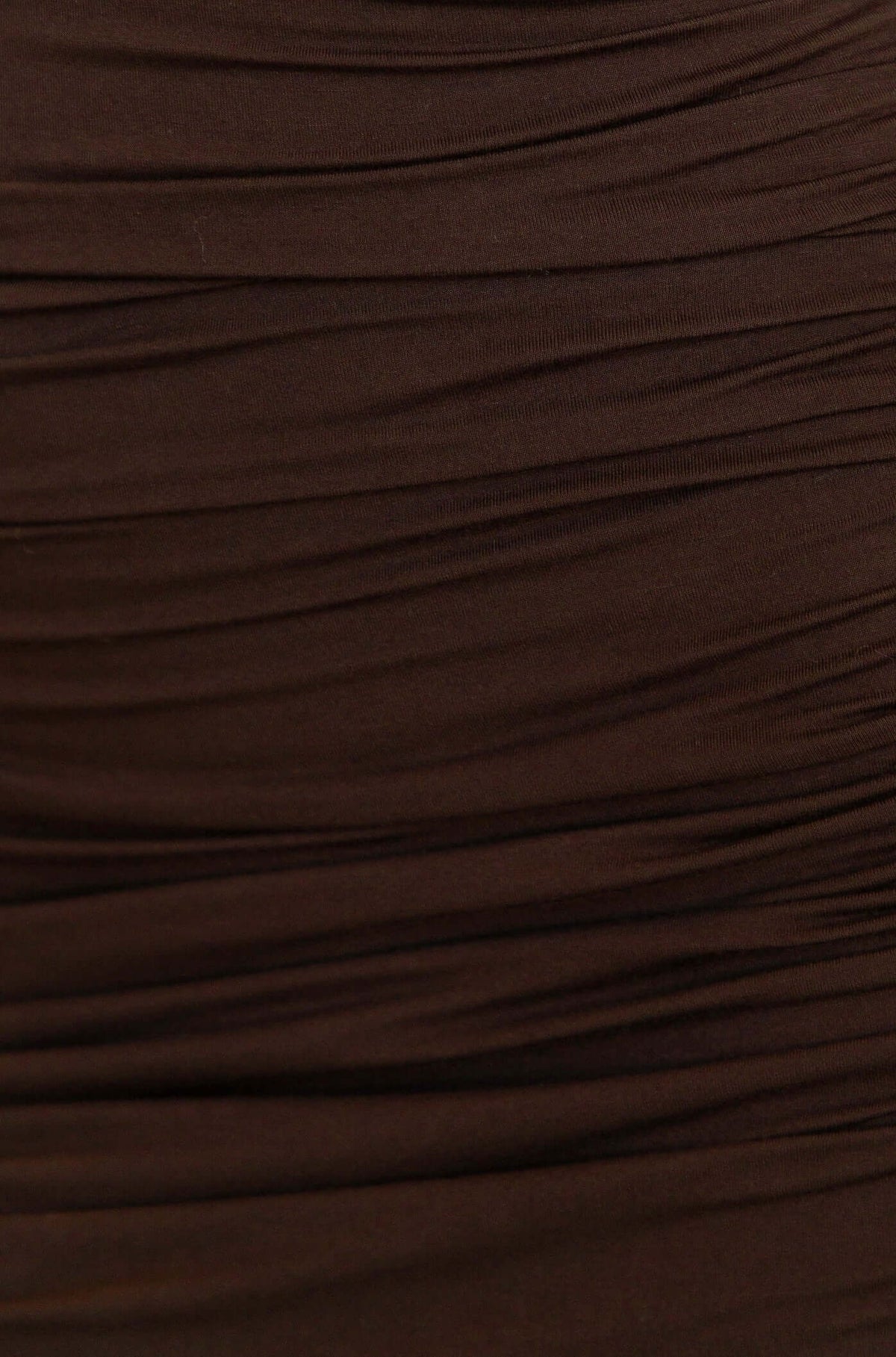 Close-up view of fabric detailing on Sutton Dress, featuring soft, ruched design in a rich brown color.