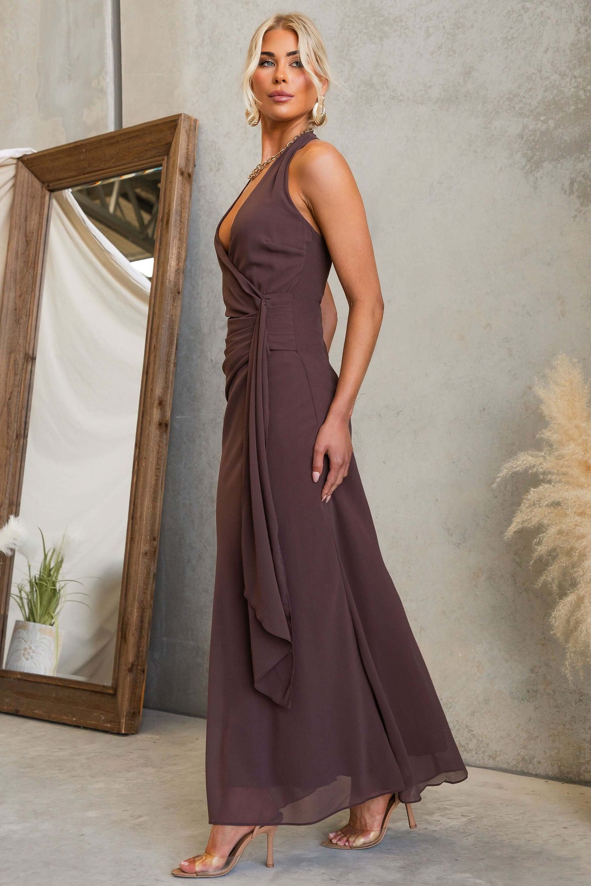 Model wearing Valmont Maxi Dress featuring a halter neckline and draping light chiffon material.