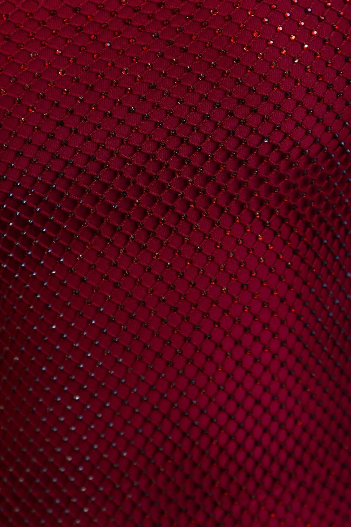 Close-up of textured metallic fabric on the Heiress Maxi Dress in red.