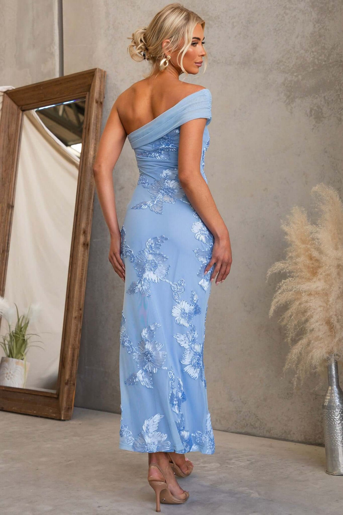 Korren Maxi Dress in light blue with one-shoulder neckline and floral embroidery, shown from the back.