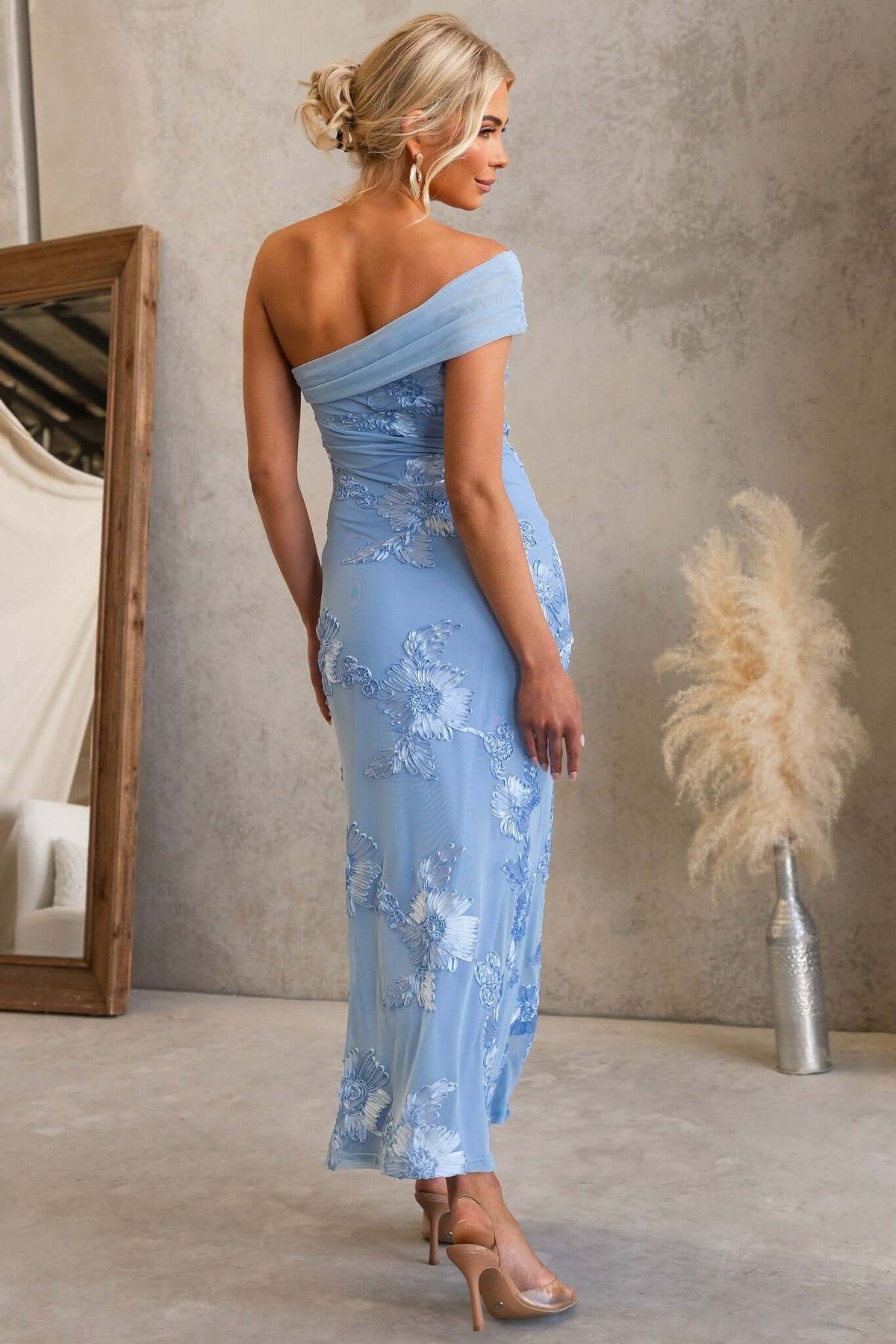 Model wearing Korren Maxi Dress with one-shoulder neckline and embroidered mesh in light blue.