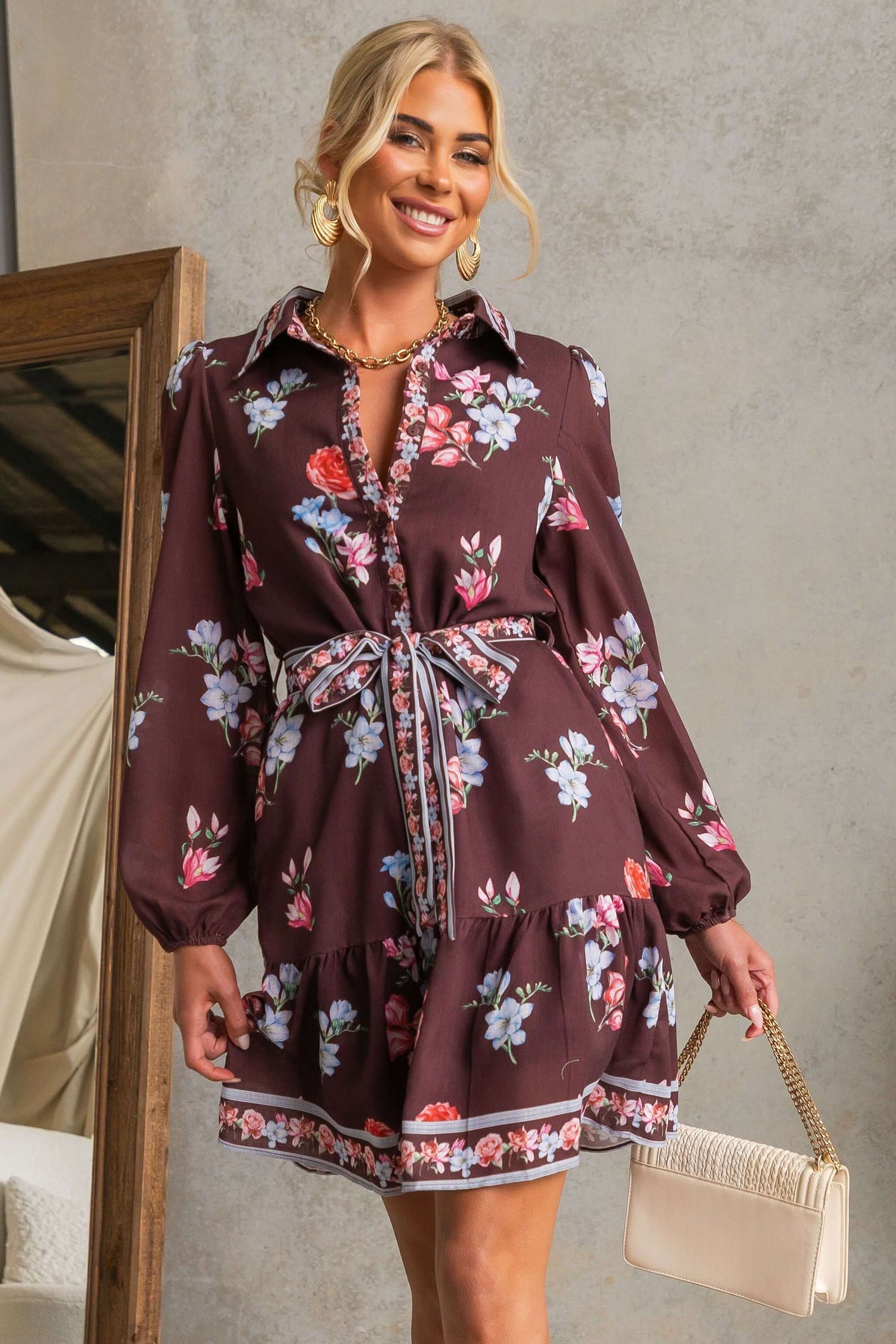 Fergy Dress featuring floral design, collar, button-up front, and removable tie, styled with handbag.