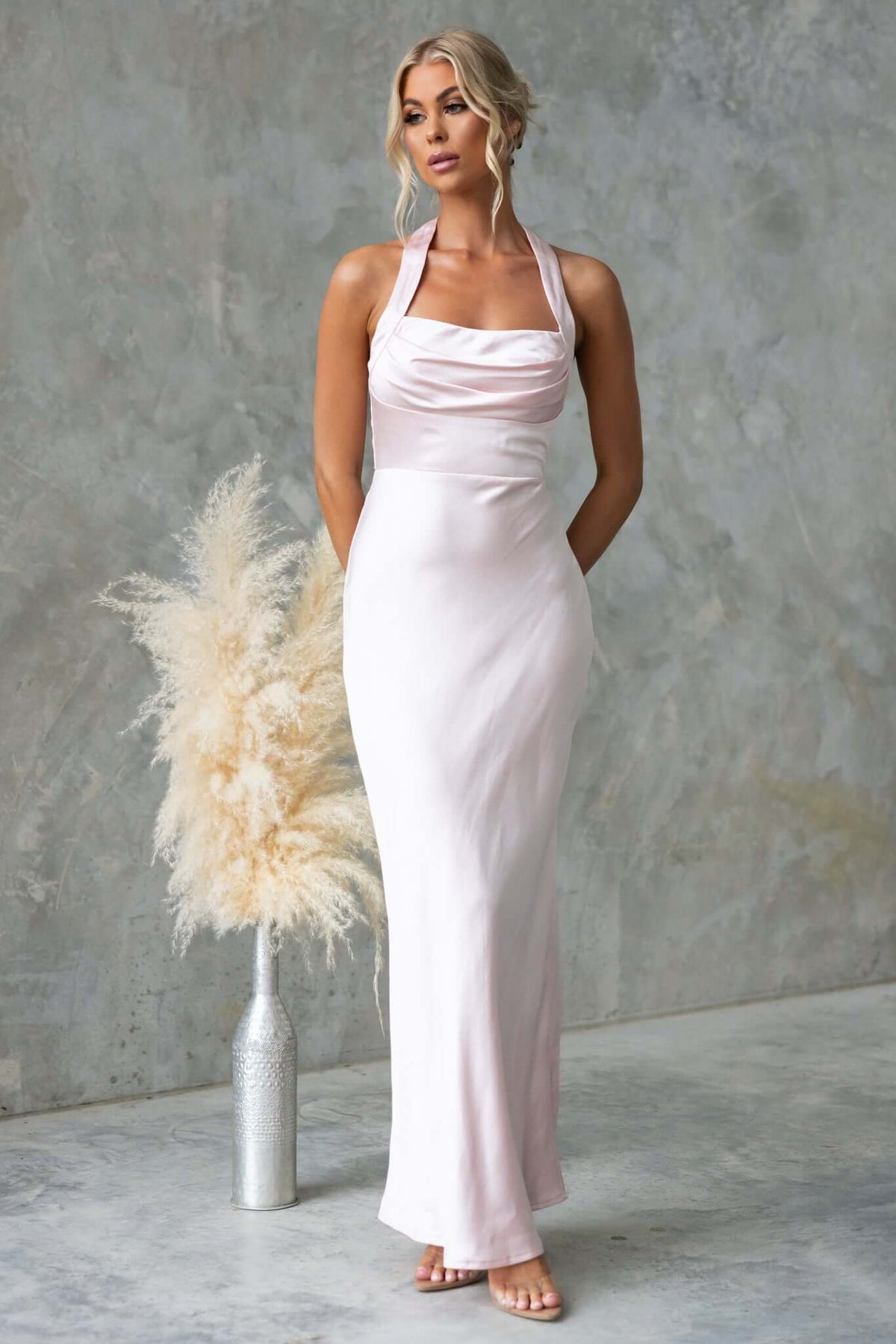 Abigail Maxi Dress in satin with halter neckline and invisible zip, styled elegantly in a soft hue.