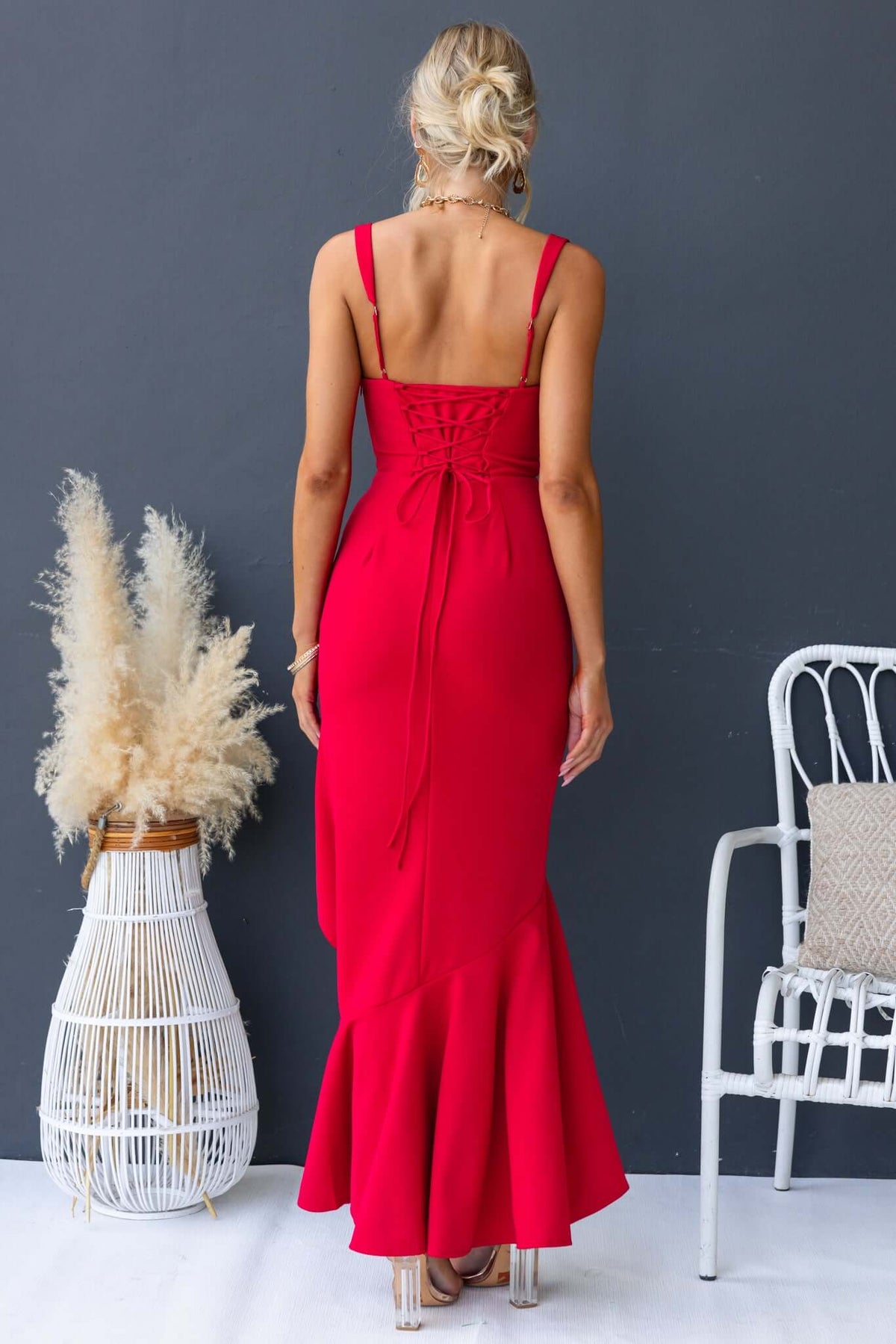 Back view of Acoma Maxi Dress in red with adjustable straps and tie at the back, showing its elegant fitted silhouette.