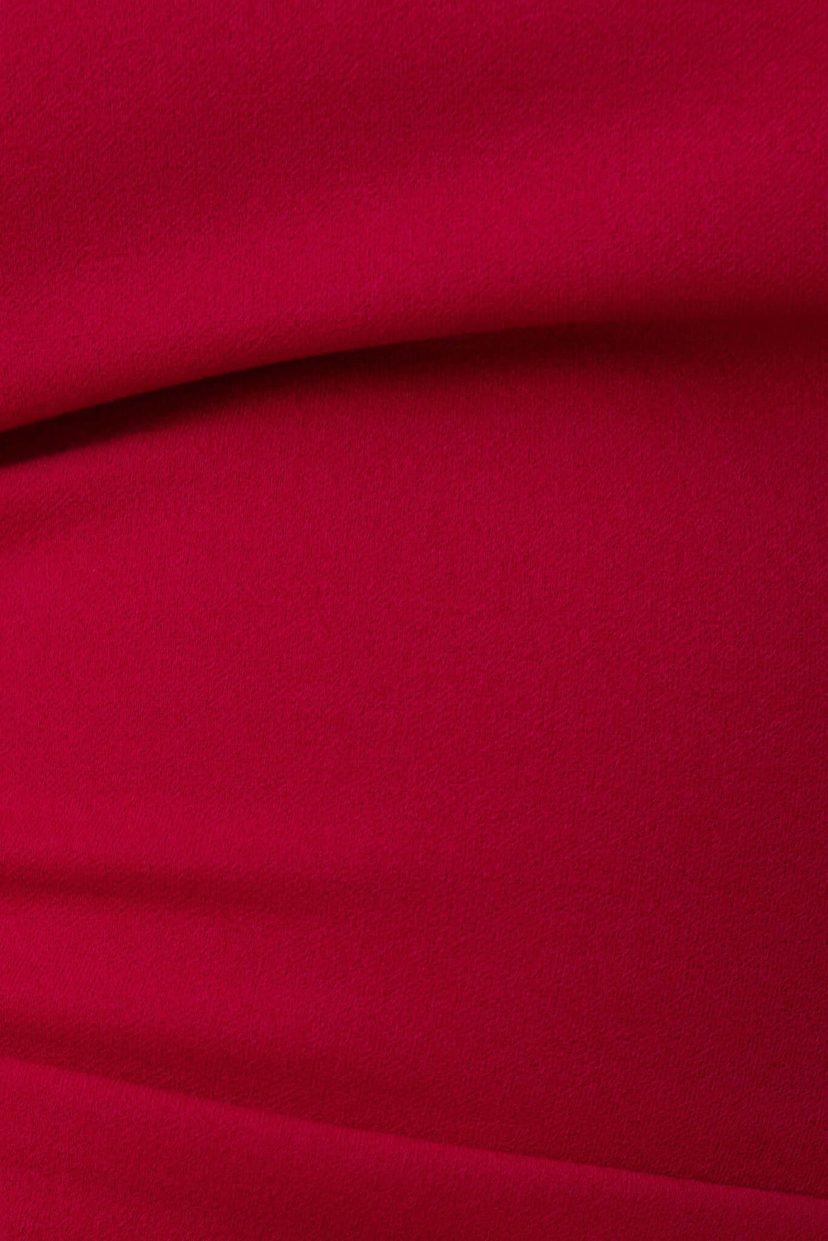 Close-up of the Acoma Maxi Dress fabric showing vibrant red color and smooth texture.