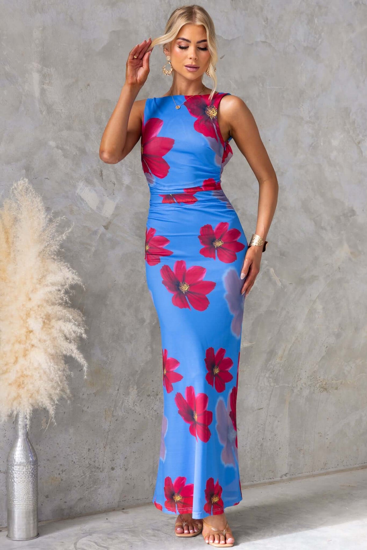 Alvara Maxi Dress featuring high neckline, adjustable straps, floral design, low-cut back, in stretchy mesh material.