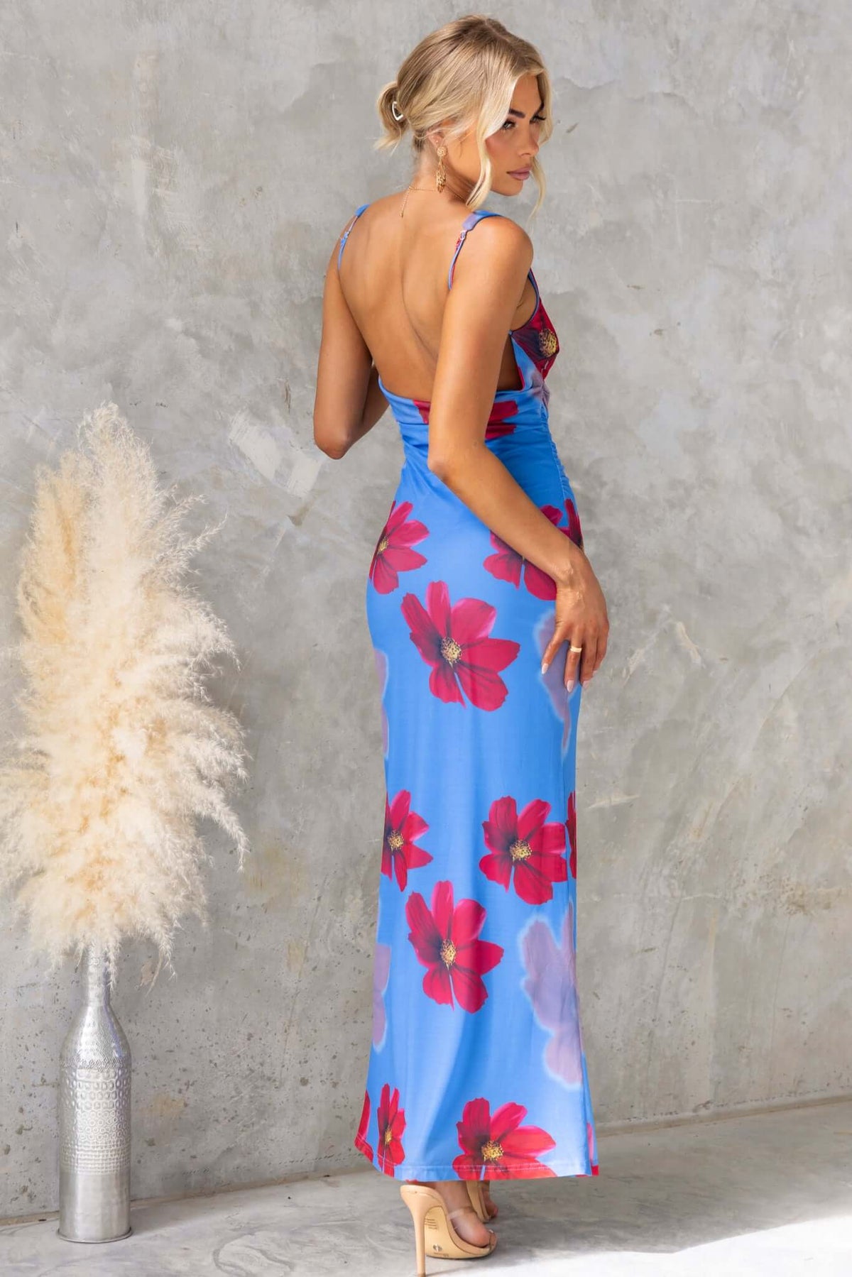 Model wearing Alvara Maxi Dress with floral print, mesh material and low-cut back, showcasing adjustable straps.