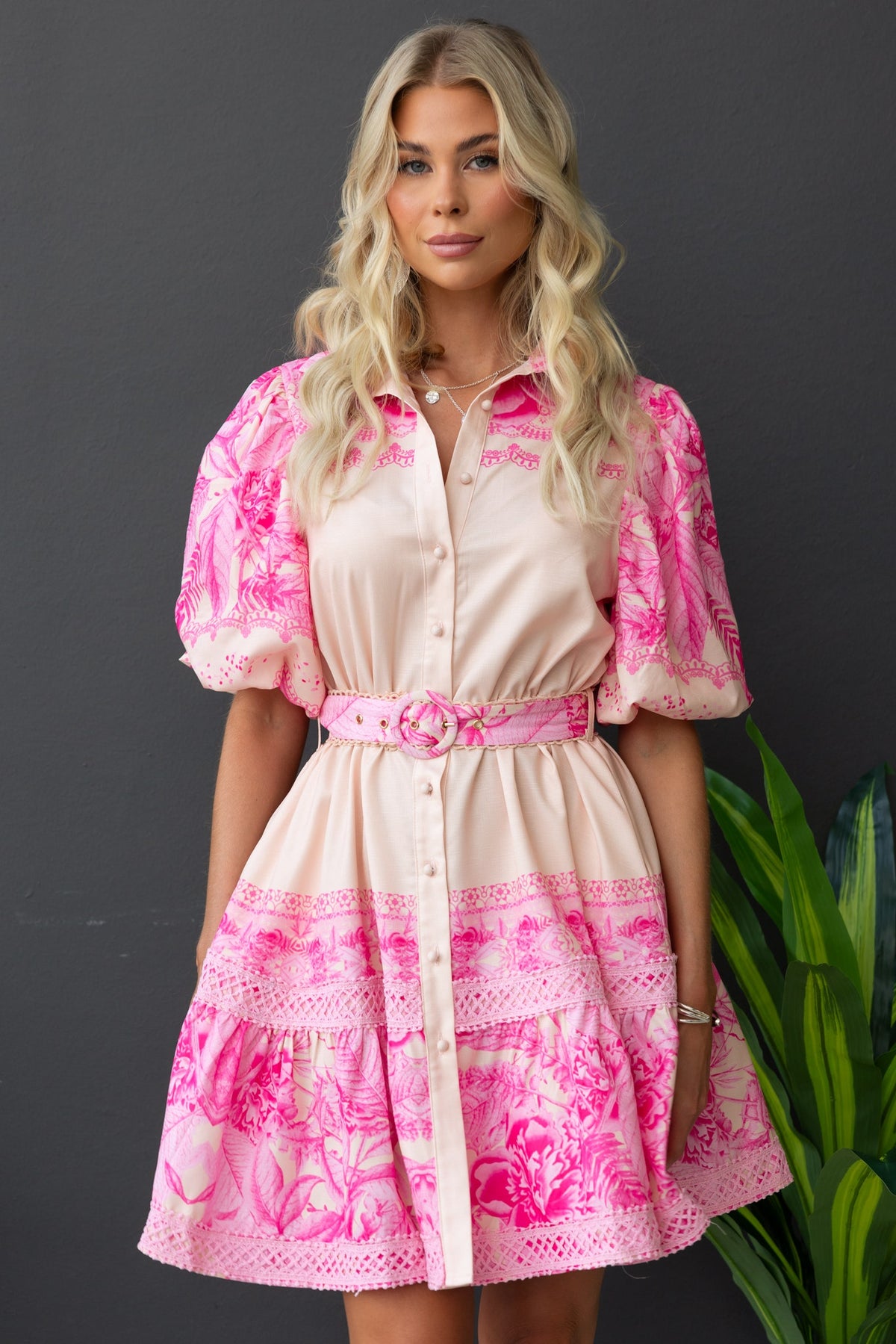 Cillie dress featuring a floral print, button-up front, elastic sleeves, and a removable belt.