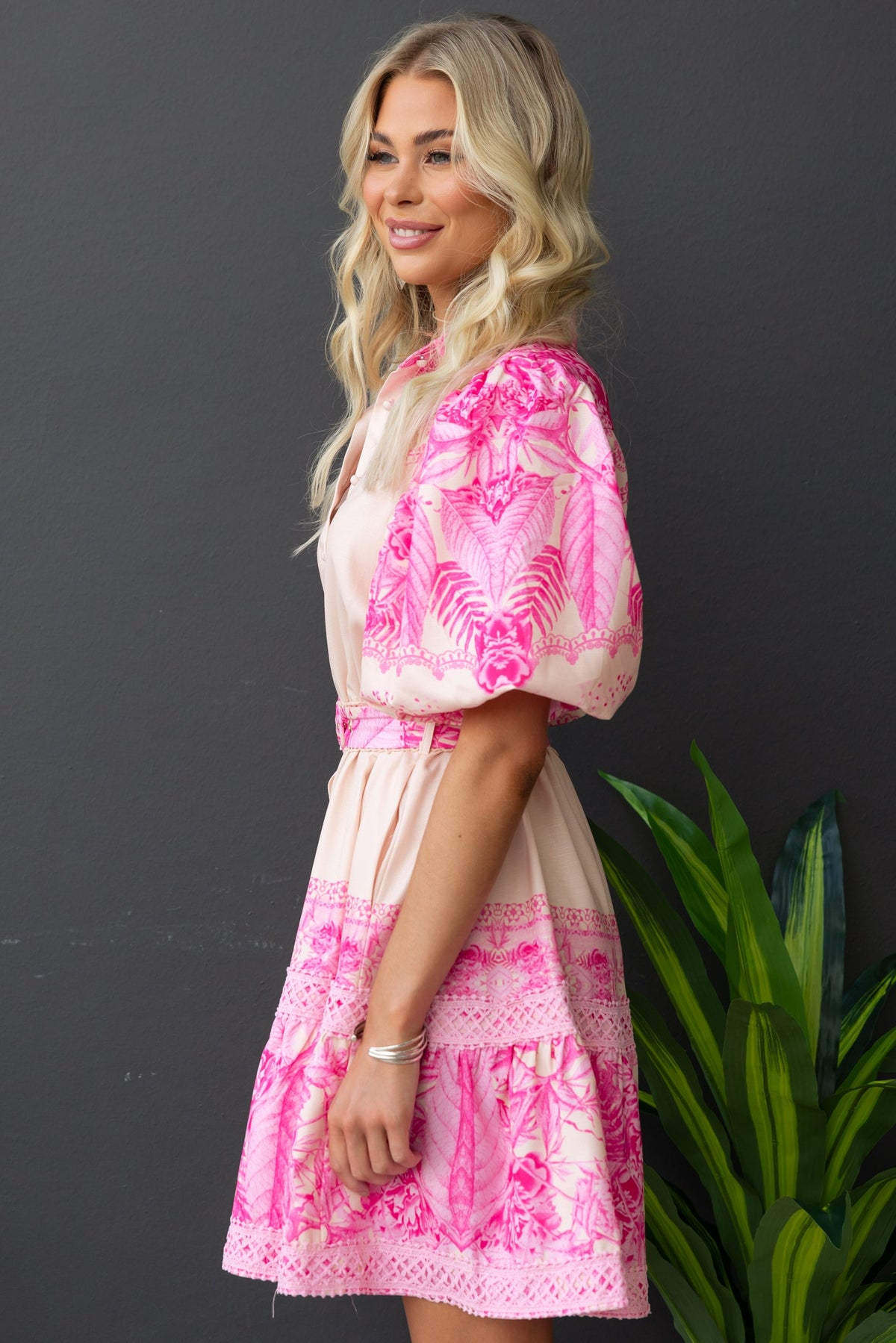 Cillie Dress featuring a floral print, button-up front, and elastic sleeves, styled with a removable belt.