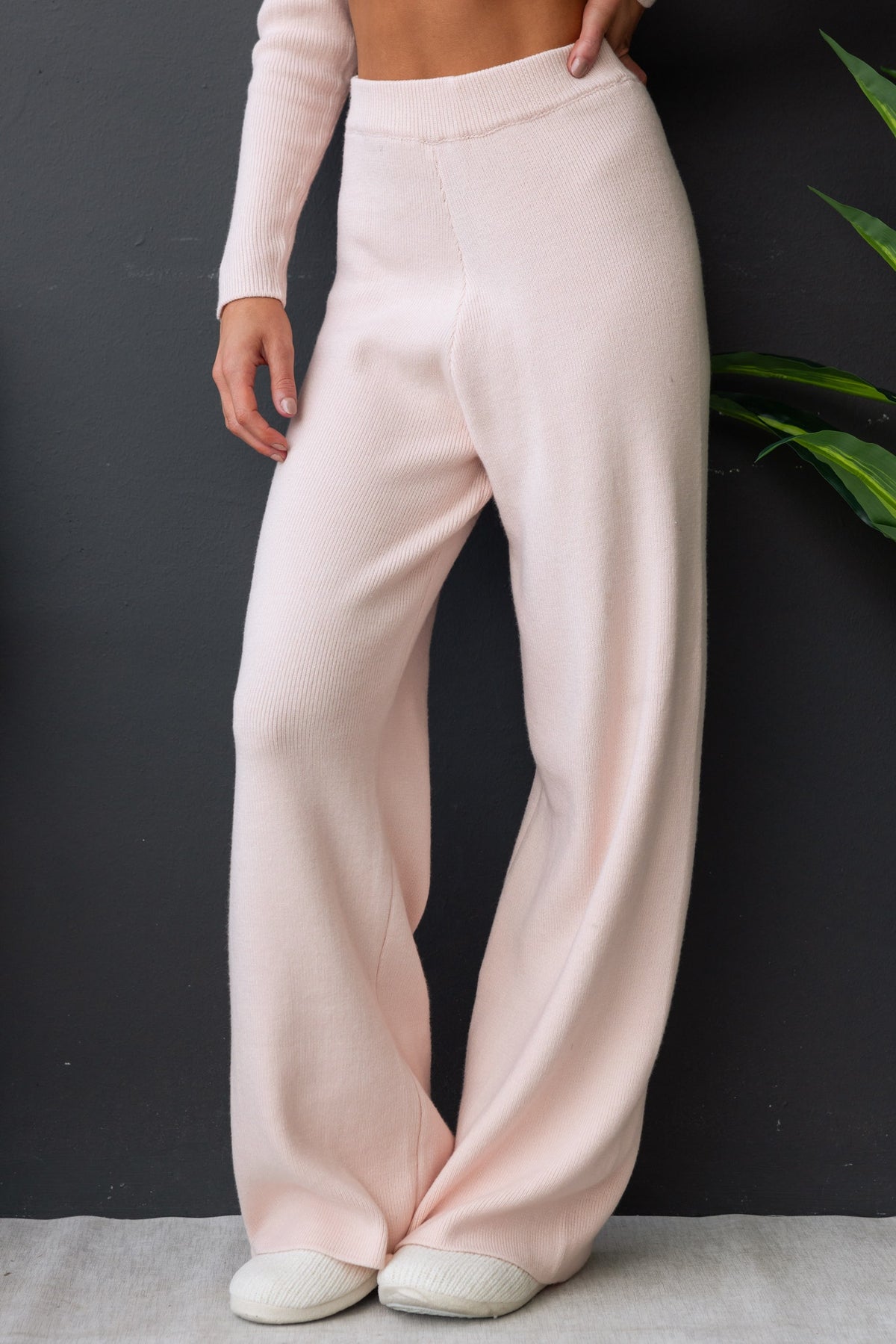 Darana Pants in soft pink, featuring a mid-high waist, elastic waistband, and comfortable knit material.