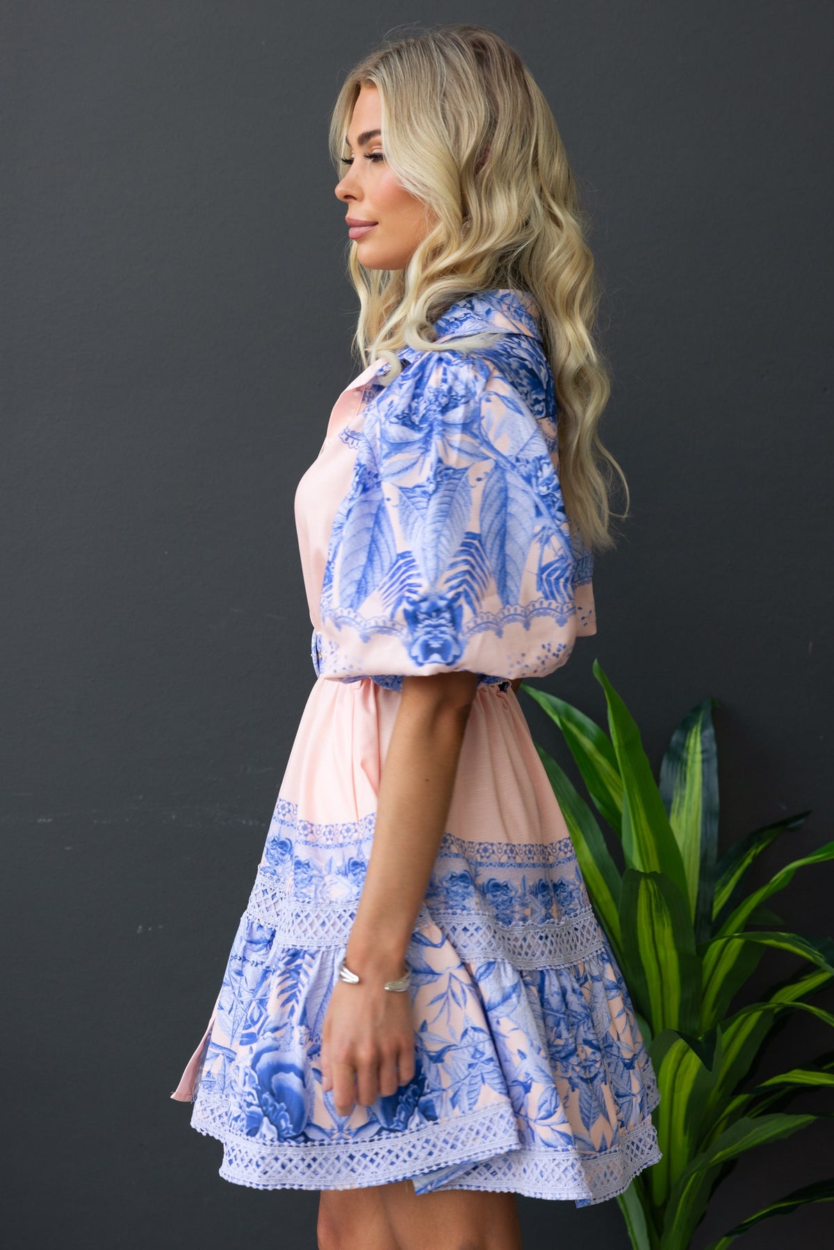 Cillie Dress featuring floral print, puff sleeves, and a removable belt, styled with a delicate blue design.