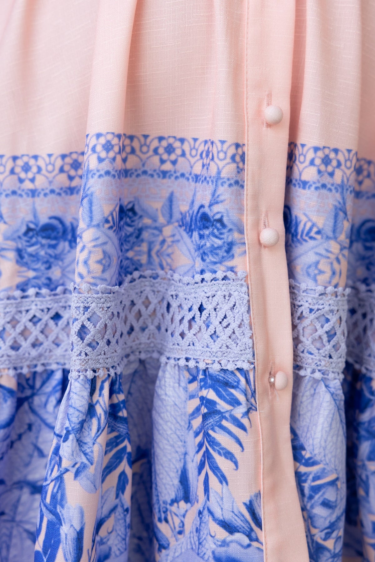 Close-up of the Cillie Dress featuring a floral print, button-up front, and delicate lace detail.