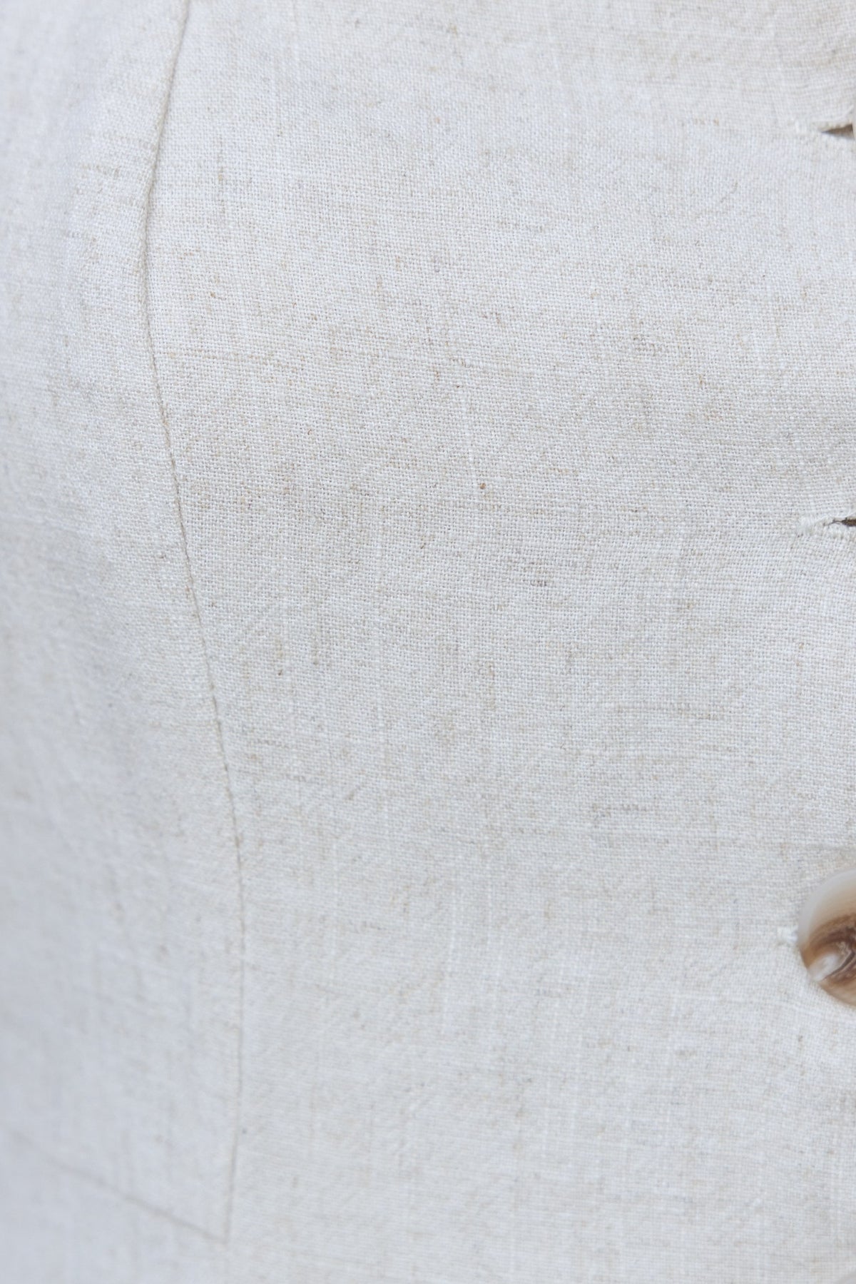 Close-up of Bexley Pants fabric showcasing linen texture and stylish button detail.