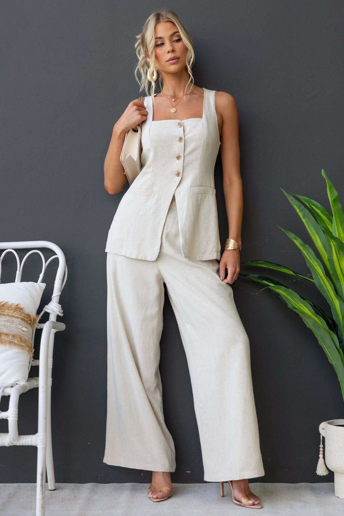 Model wearing Bexley Pants, featuring mid-high waist and linen look, styled with a matching top in a neutral setting.
