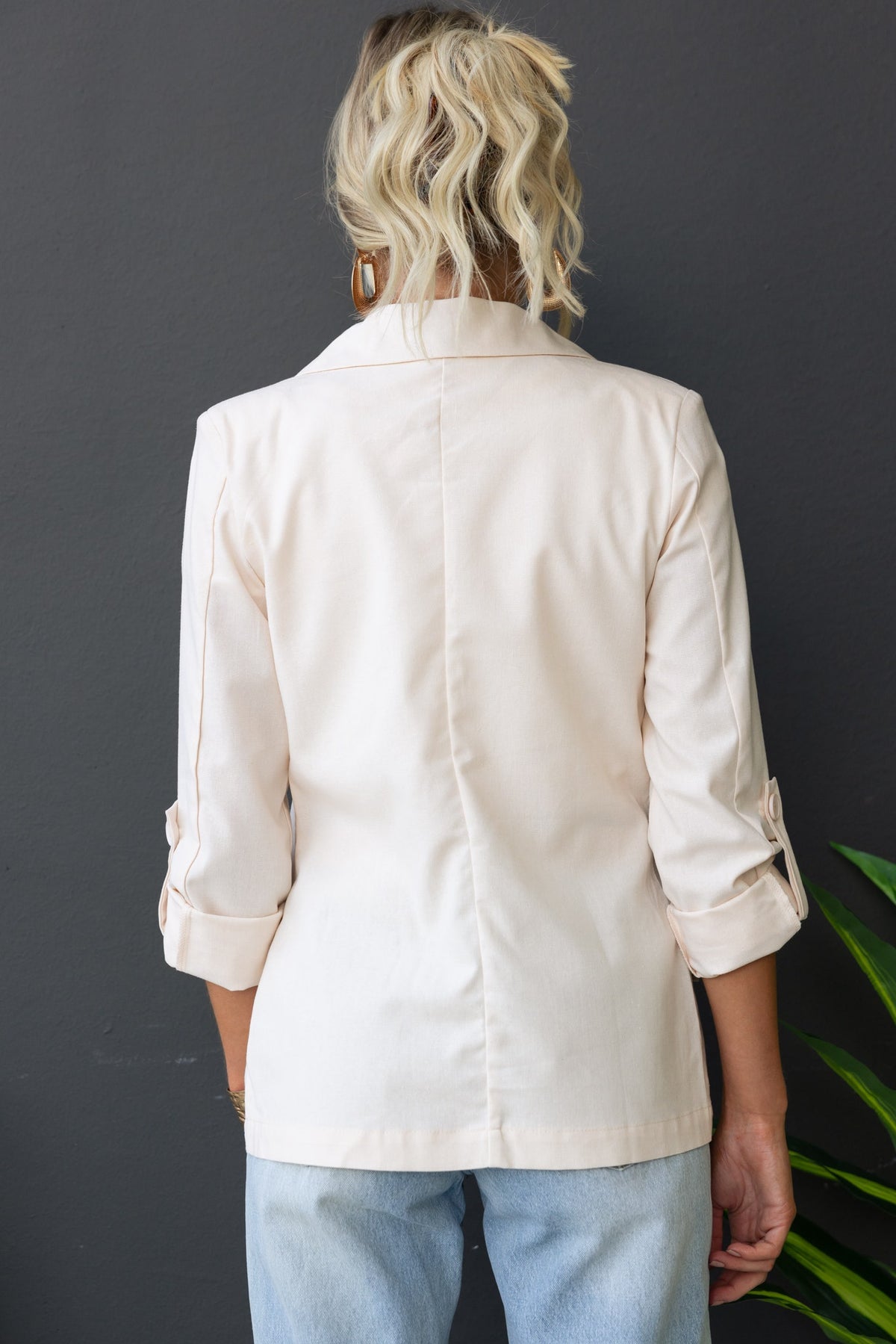 Back view of Merci Blazer showcasing its collar, shoulder pads, and rolled sleeves in a stylish fit.