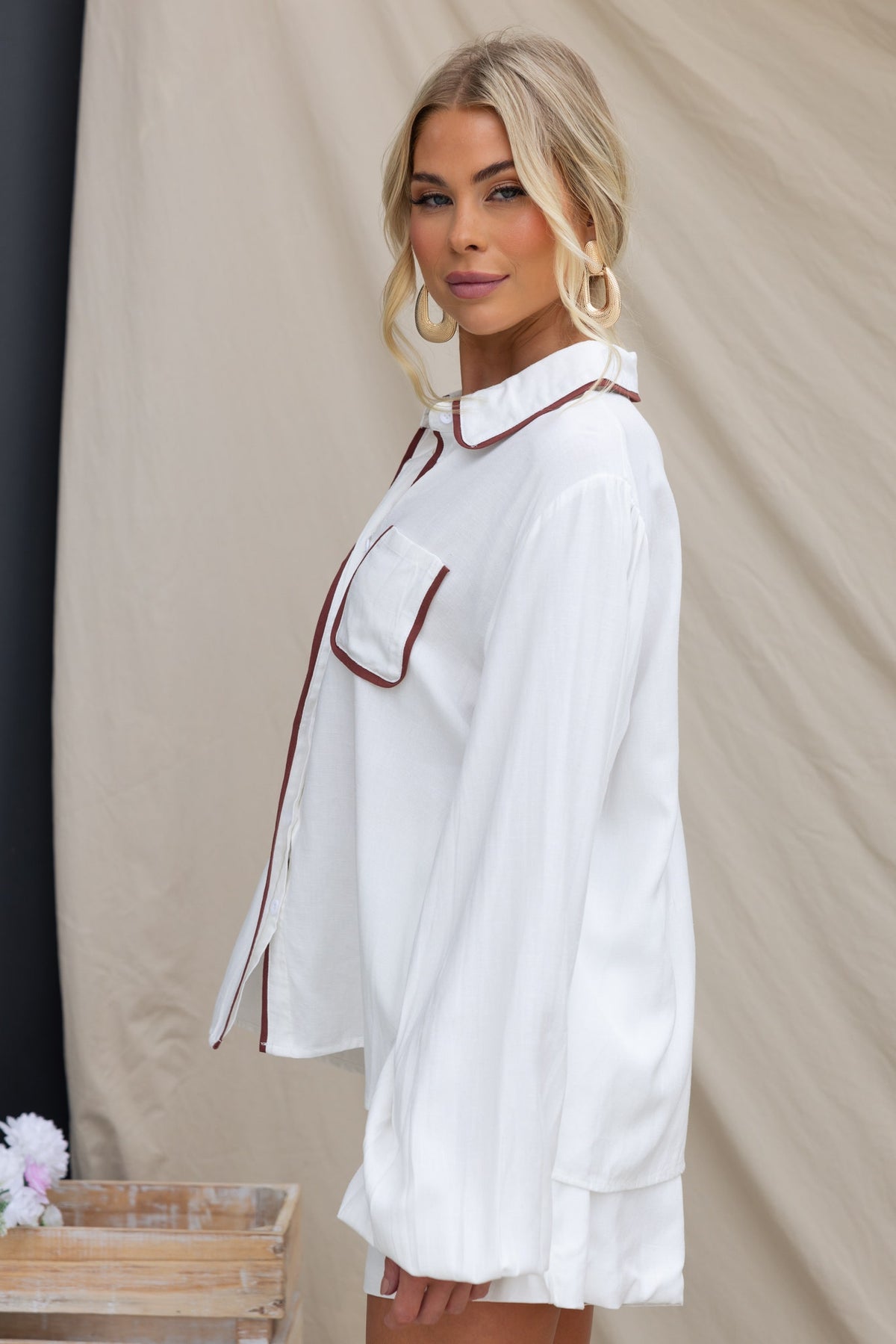 Side view of the Ronnie Shirt featuring a button-up front, collar, and elastic sleeves in a linen-look fabric.