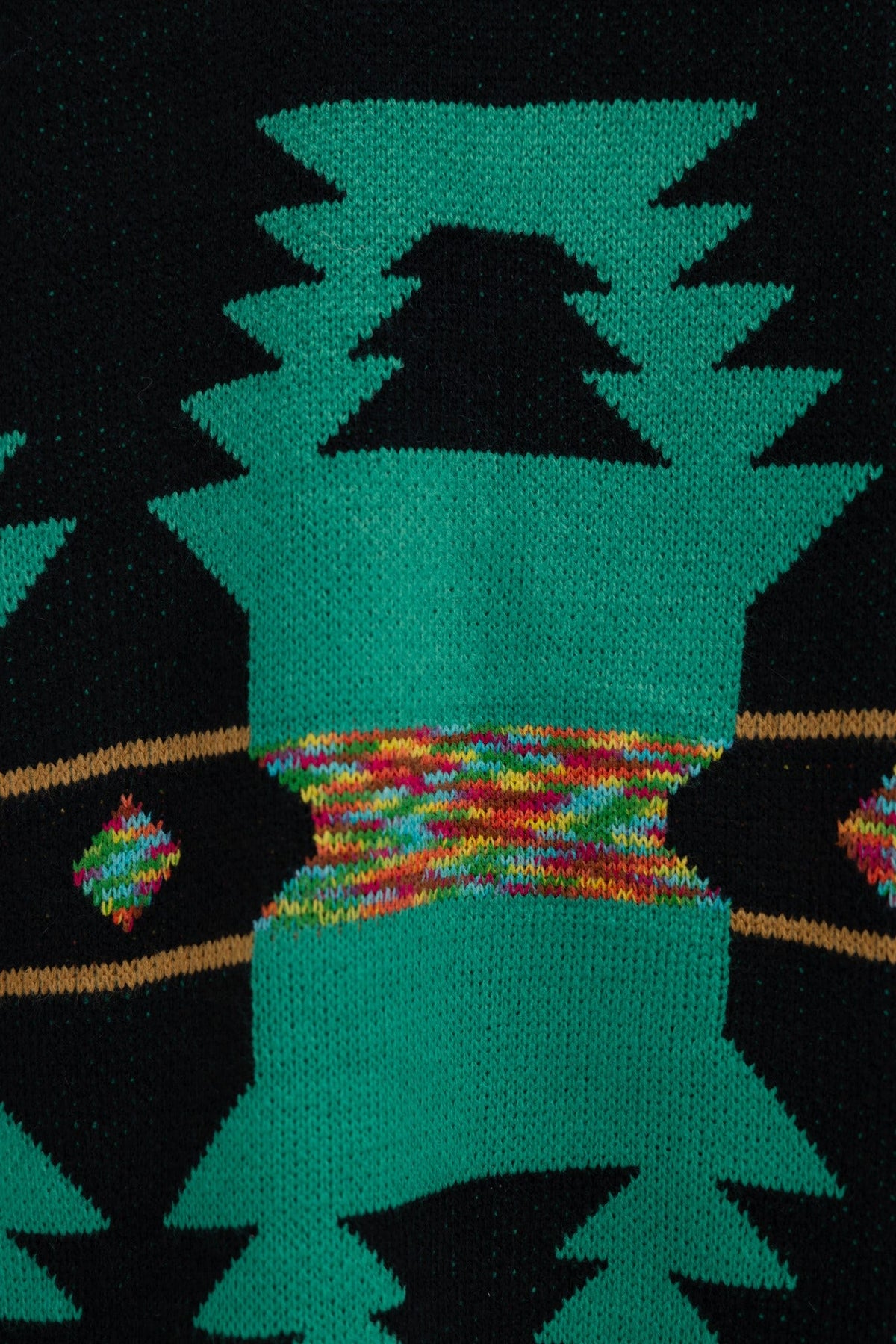 Close-up of the Lazuli Cardigan, featuring a colorful print on a black base with geometric designs.