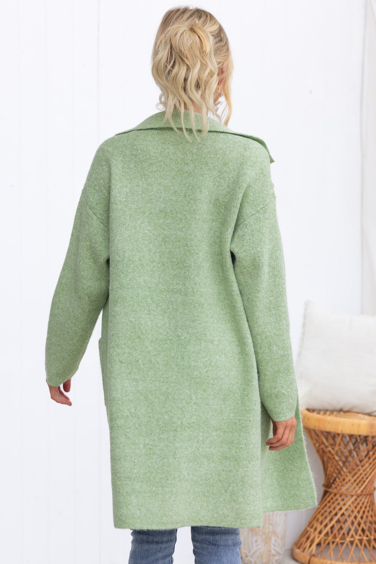 Back view of a green Sarlia Cardigan with a collar, featuring a relaxed fit in a cozy knit material.