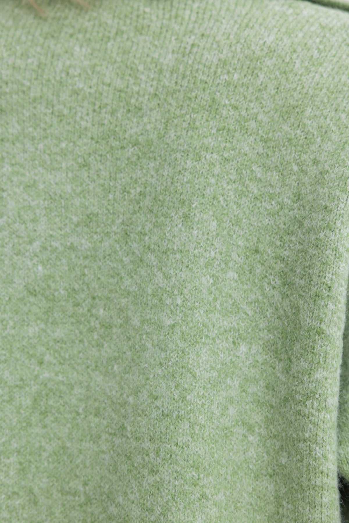 Close-up of Sarlia Cardigan in soft green knit material showcasing texture and color.