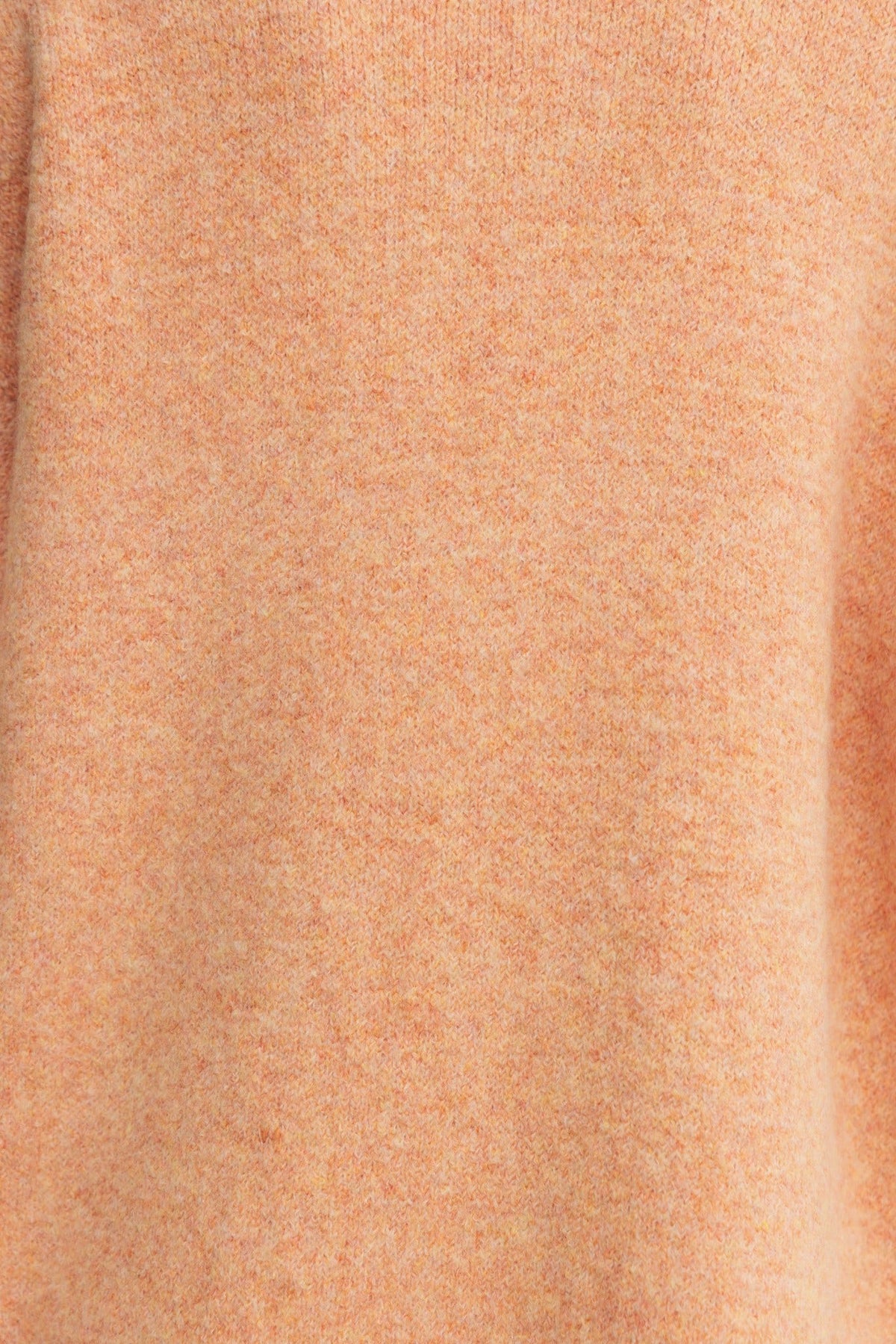 Close-up of Sarlia Cardigan fabric in soft peach color, highlighting its knit texture and cozy feel.