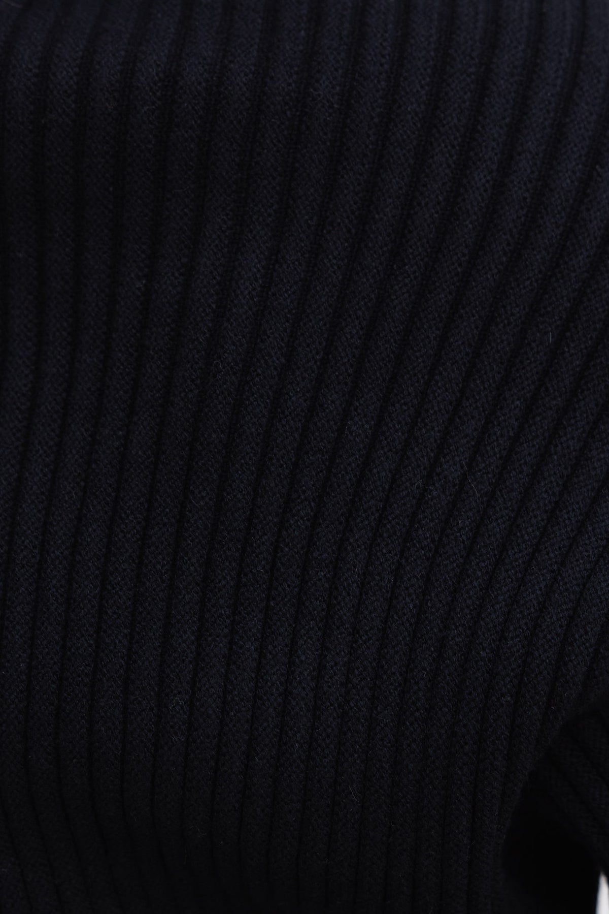 Close-up of black ribbed knit fabric showcasing texture and stretch, ideal for Sola Jumper design.