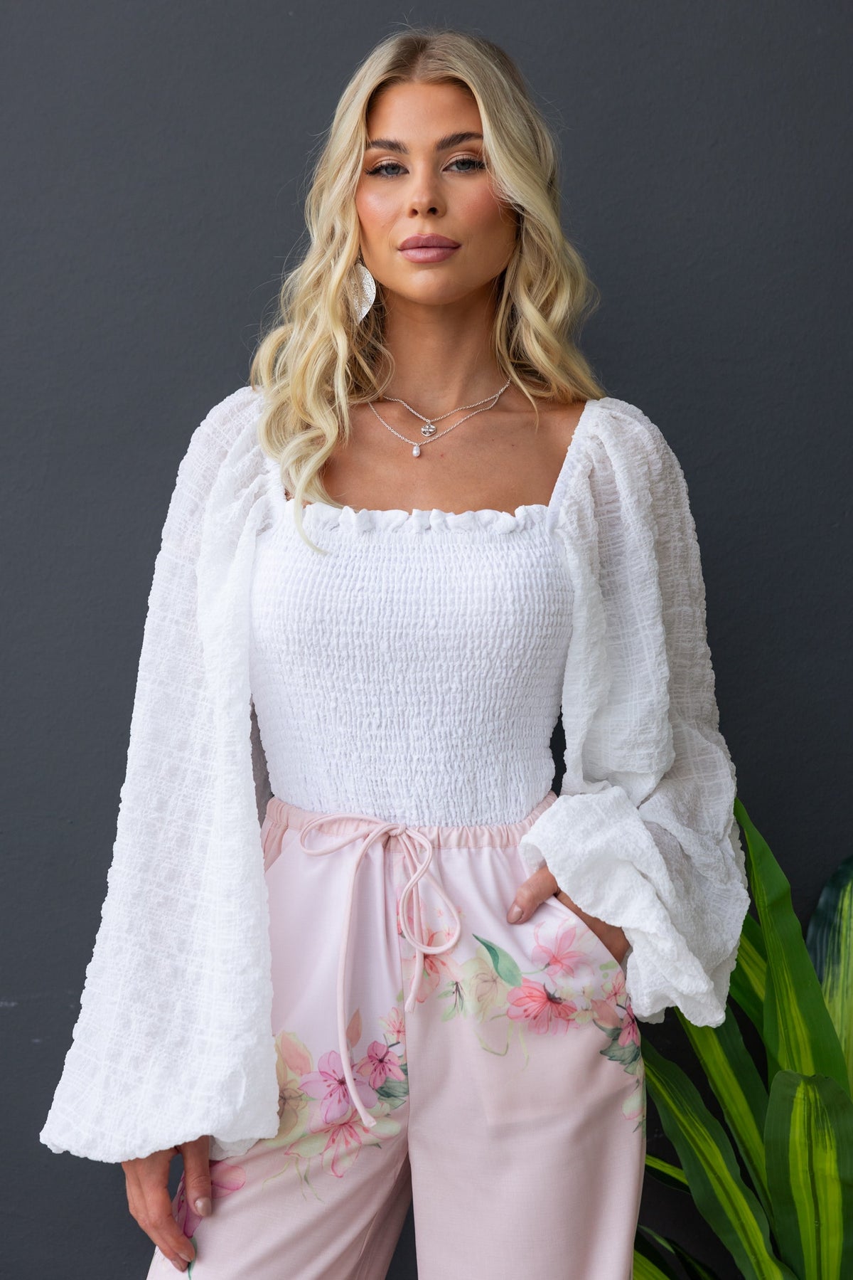 Joey Top with square neckline, elastic bodice, and textured material worn with floral trousers, perfect for a stylish look.