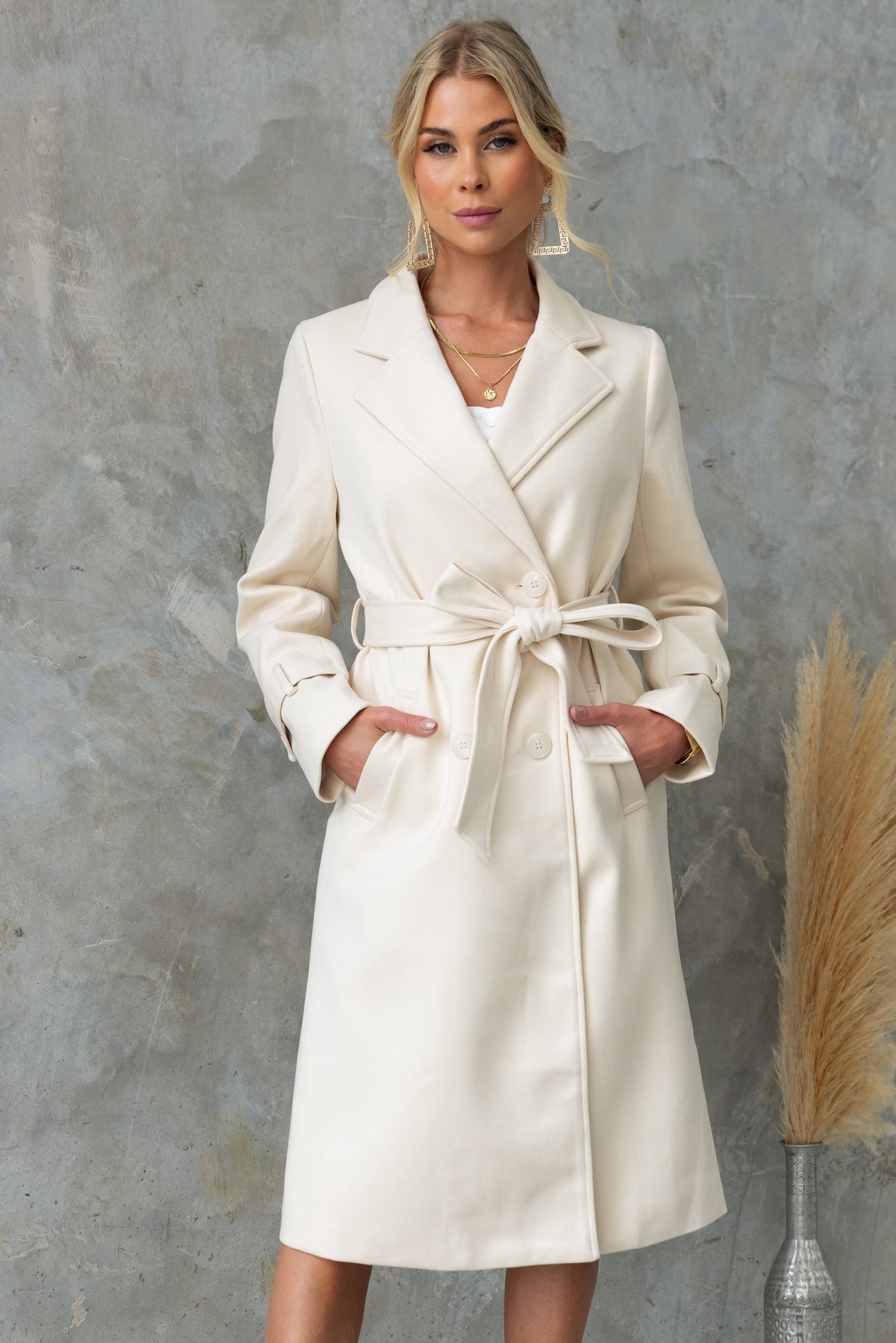 Lansen Coat in ivory, longline fit with collar, button-up front, pockets, removable tie, and back split