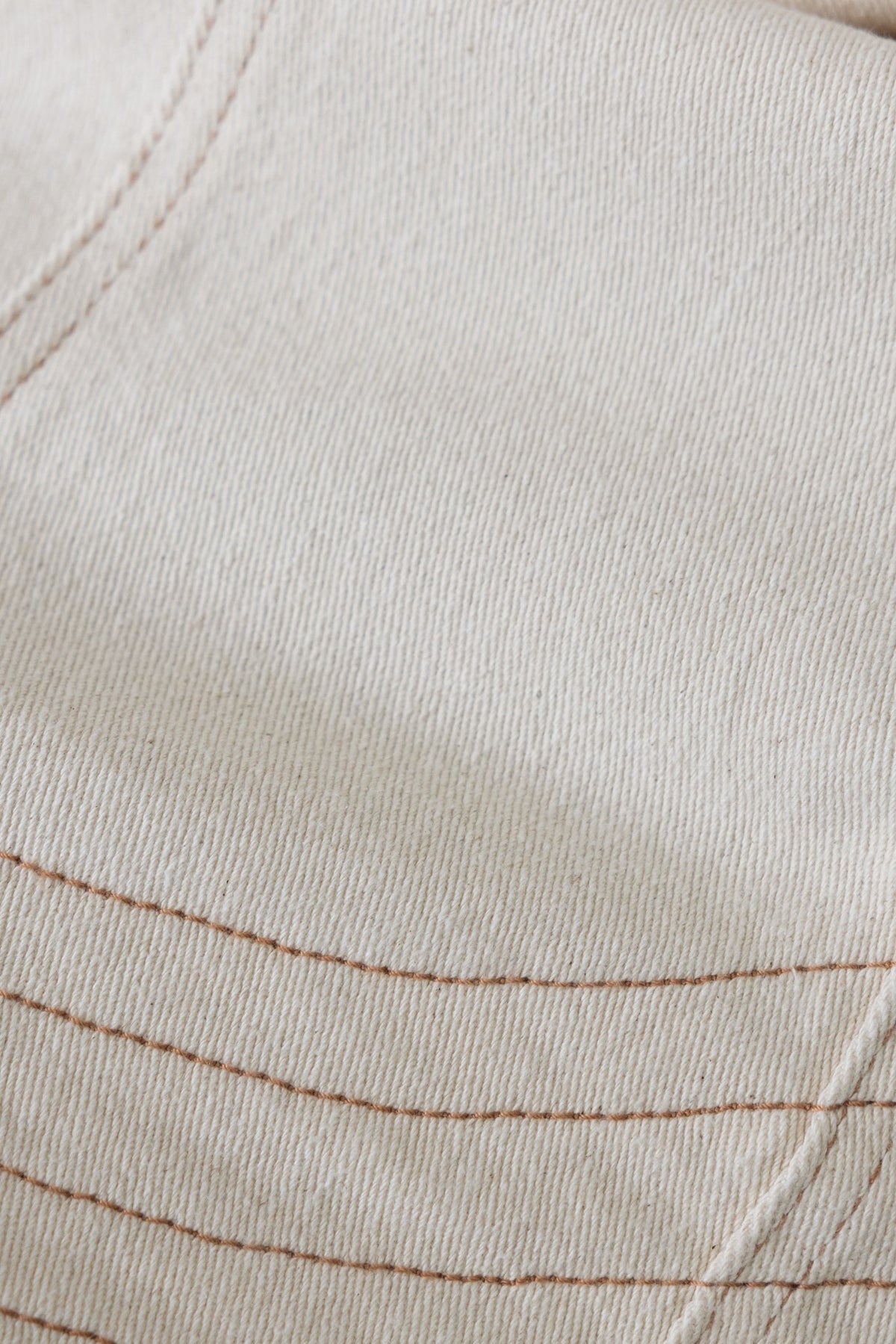 Close-up of textured denim fabric featuring stitching details, showcasing the quality of the Kaylen Denim Jacket.
