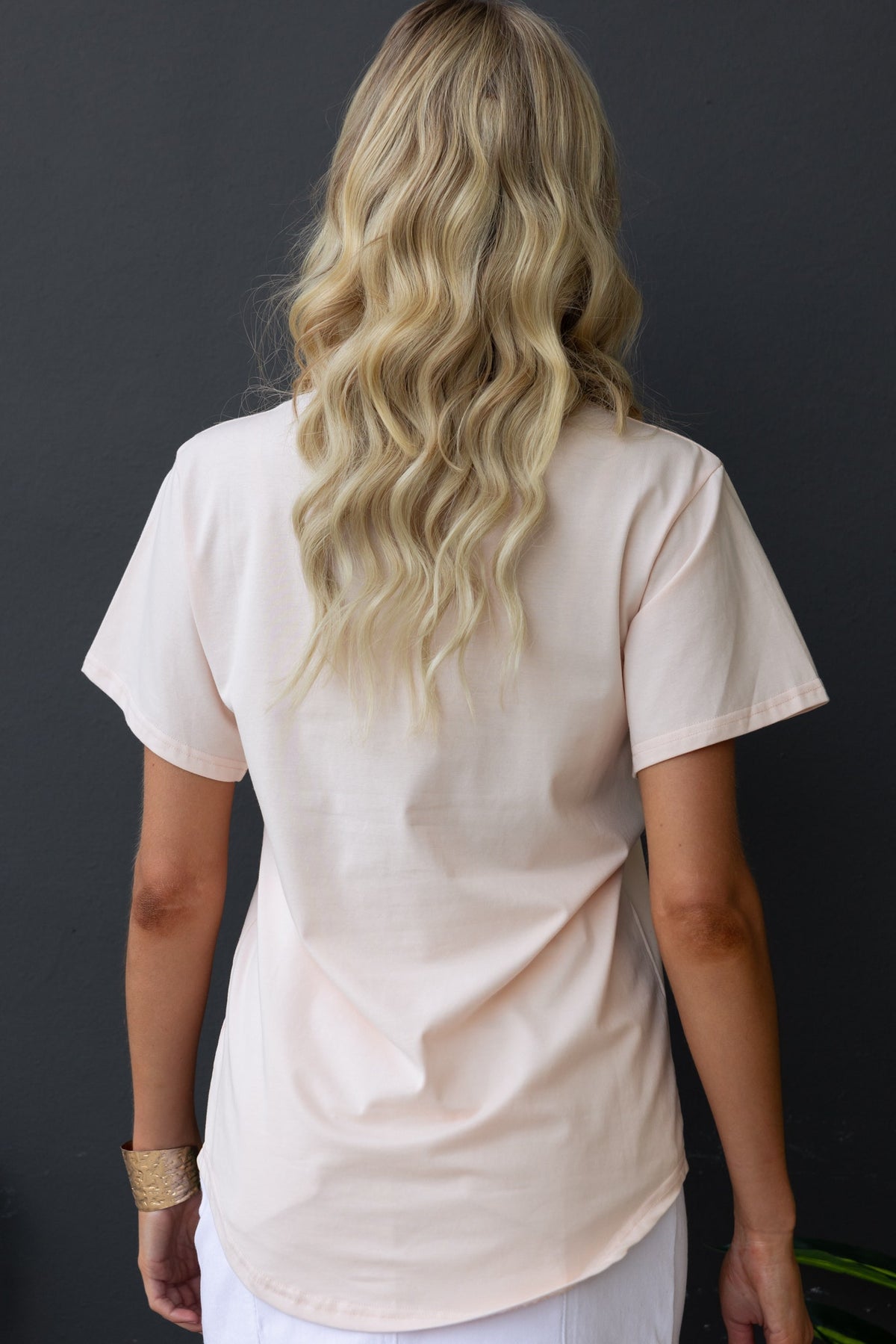 Back view of the Cesca Tee, a light soft cotton shirt with a round neckline and short sleeves, ideal for casual wear.