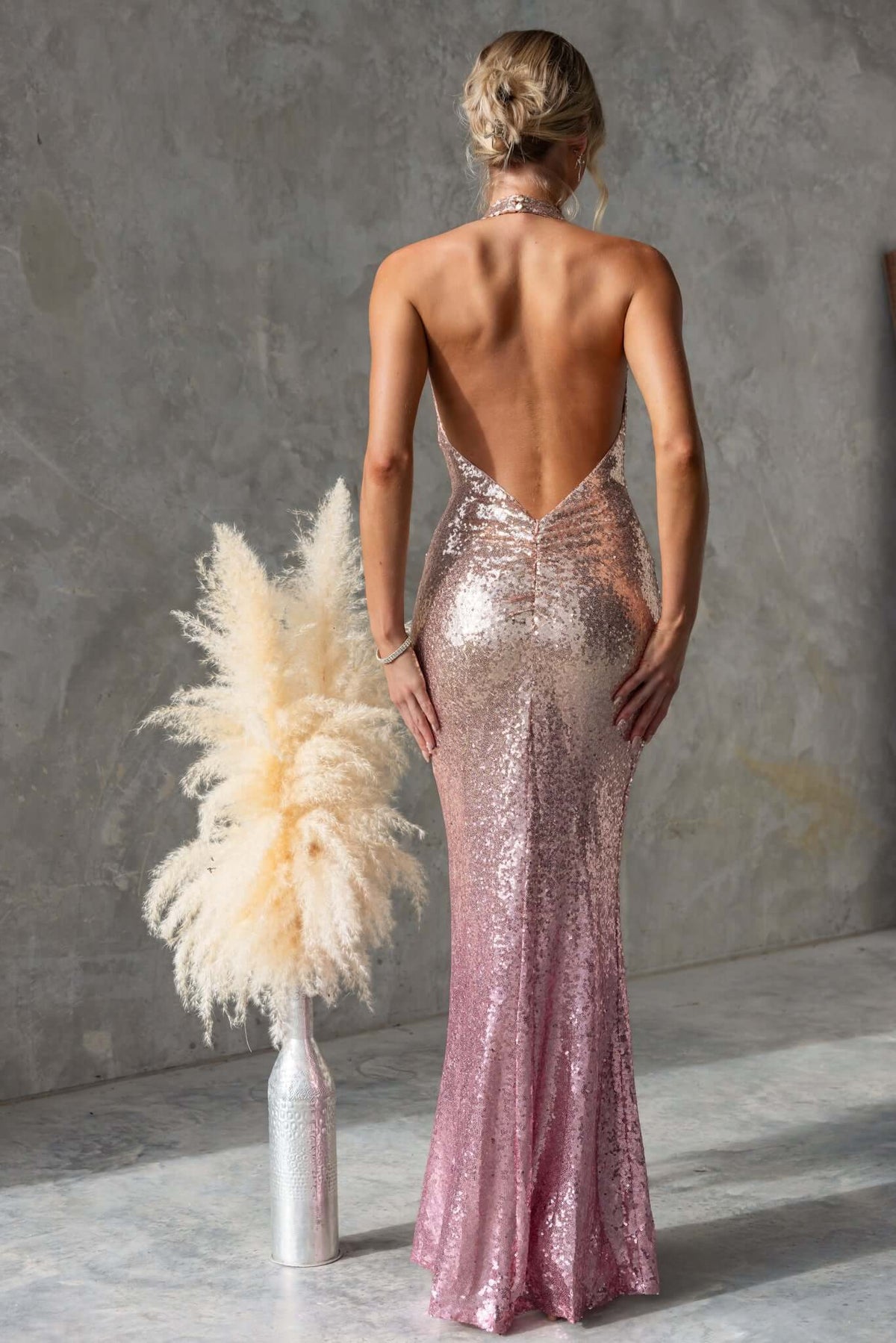 Back view of Amaris Maxi Dress, a sequin gown with cowl neckline and V-cut back in a pink gradient.