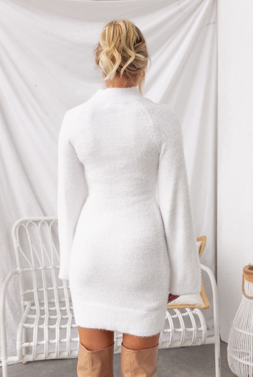 Back view of Arise Dress featuring fluffy yarn, high neckline, and balloon sleeves in a stylish white design.