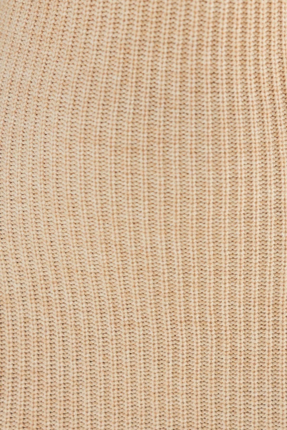 Close-up of the knit material in a beige color, showcasing the ribbed texture of the fabric used in the Layana Midi Dress.