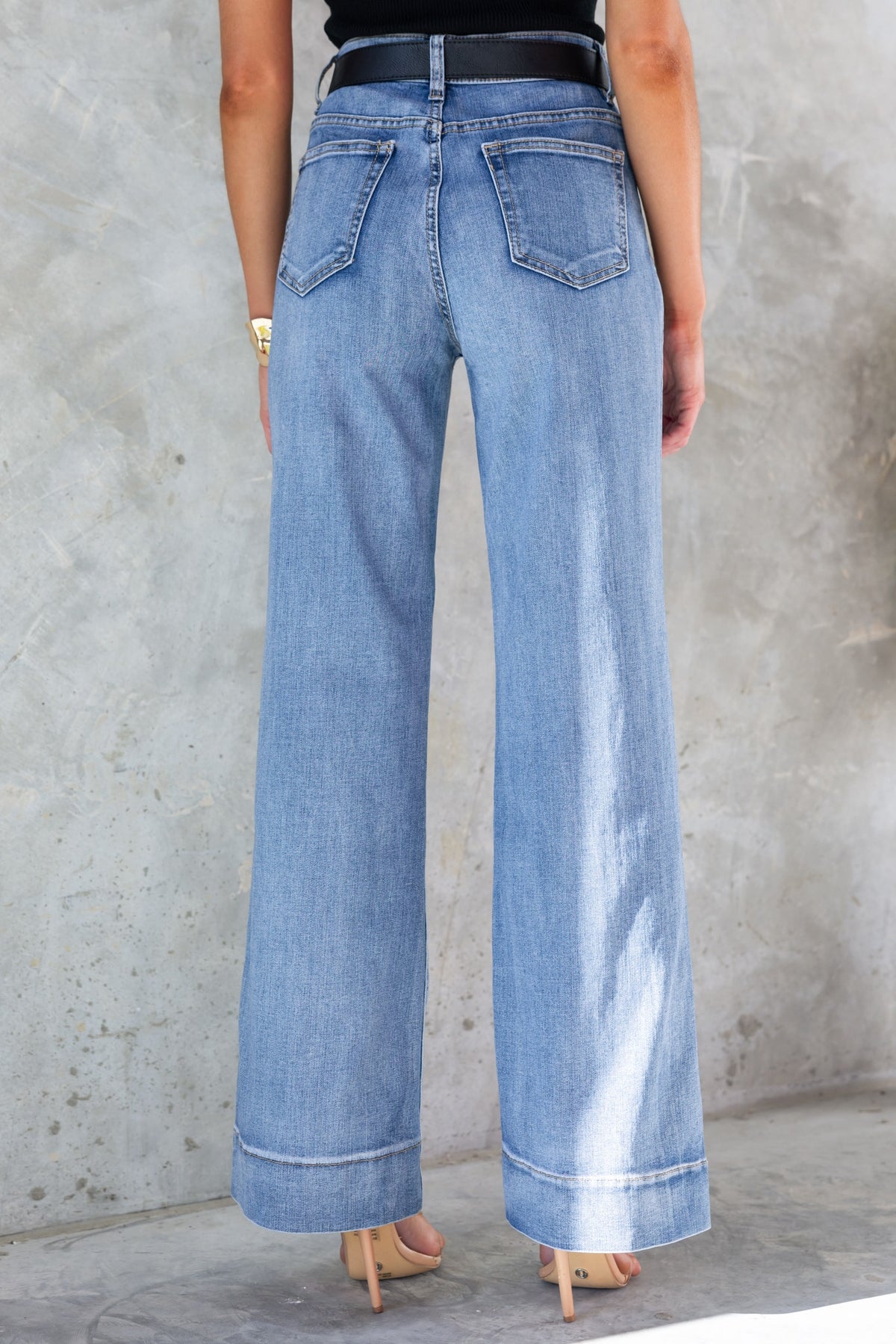 Back view of Damon Jeans showcasing a mid-high waist and straight leg fit in light blue denim.