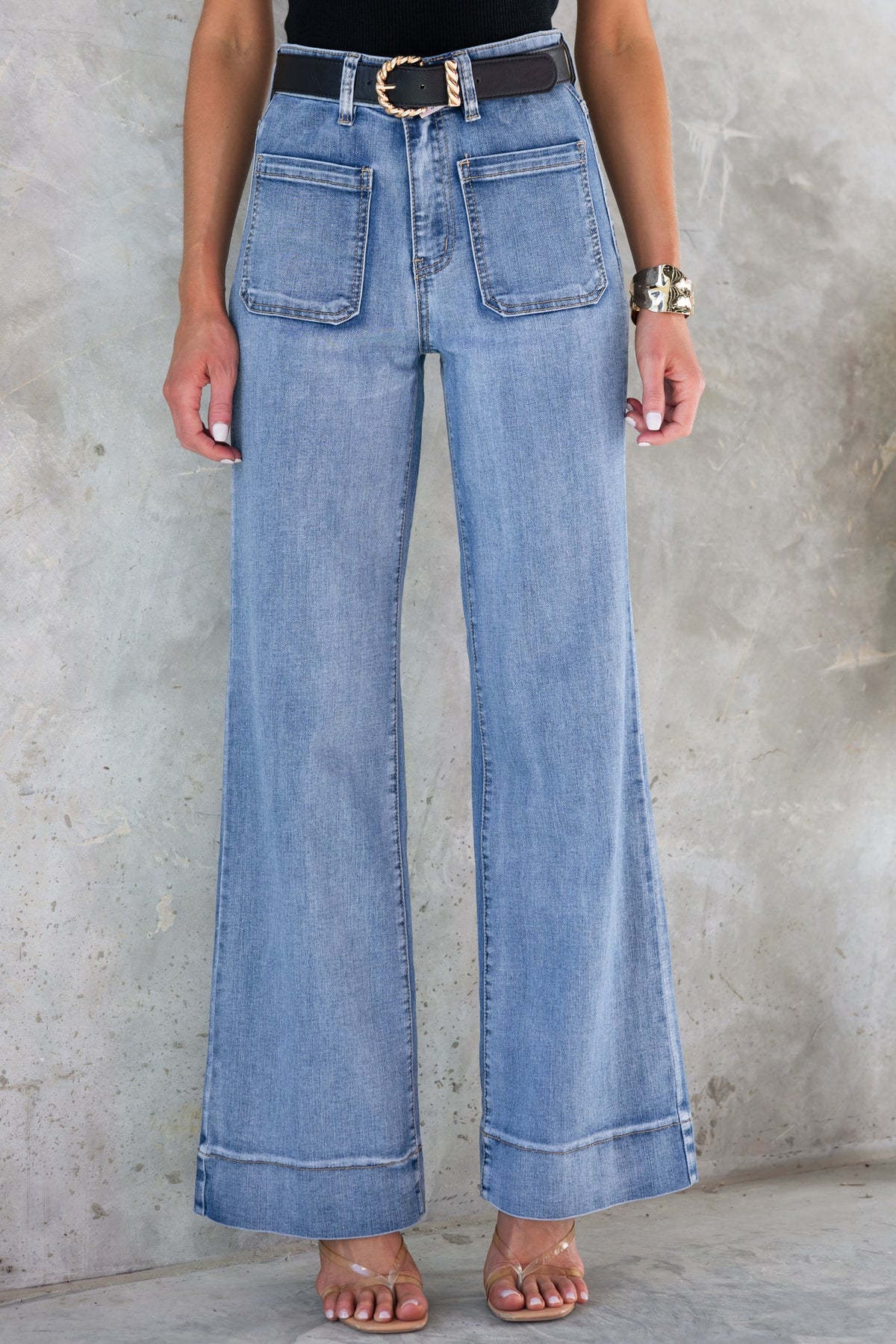 Woman wearing Damon Jeans, mid-high waist with straight leg fit, front and back pockets, and stylish cuffed hem.